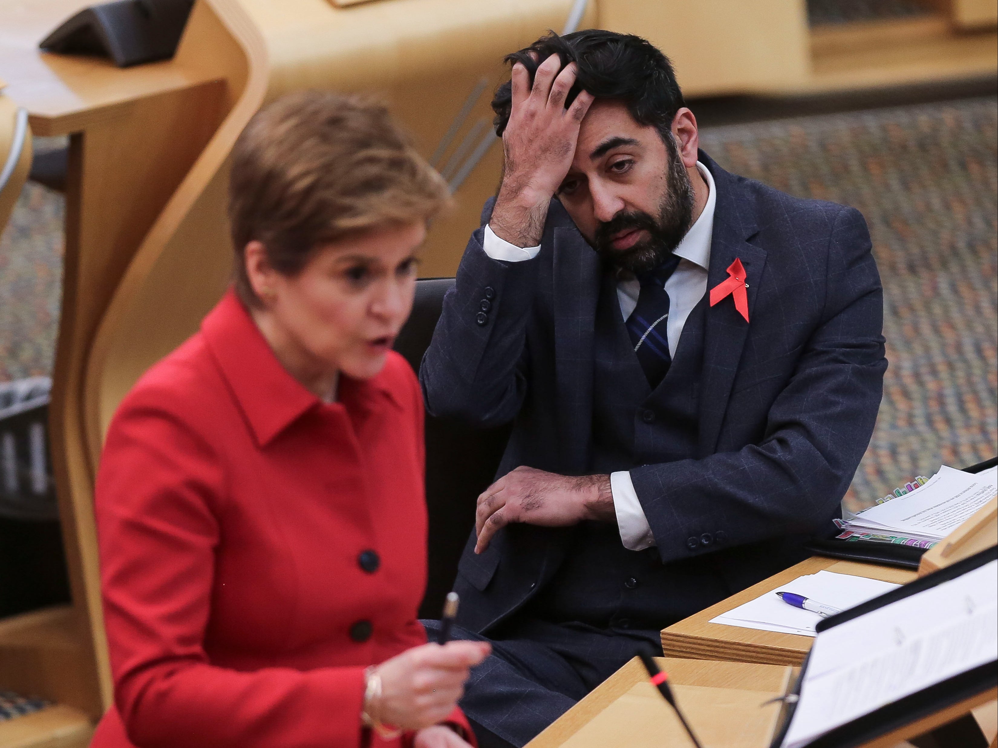 Scotland’s health secretary Humza Yousaf looks on as Scotland’s first minister Nicola Sturgeon speaks in Holyrood