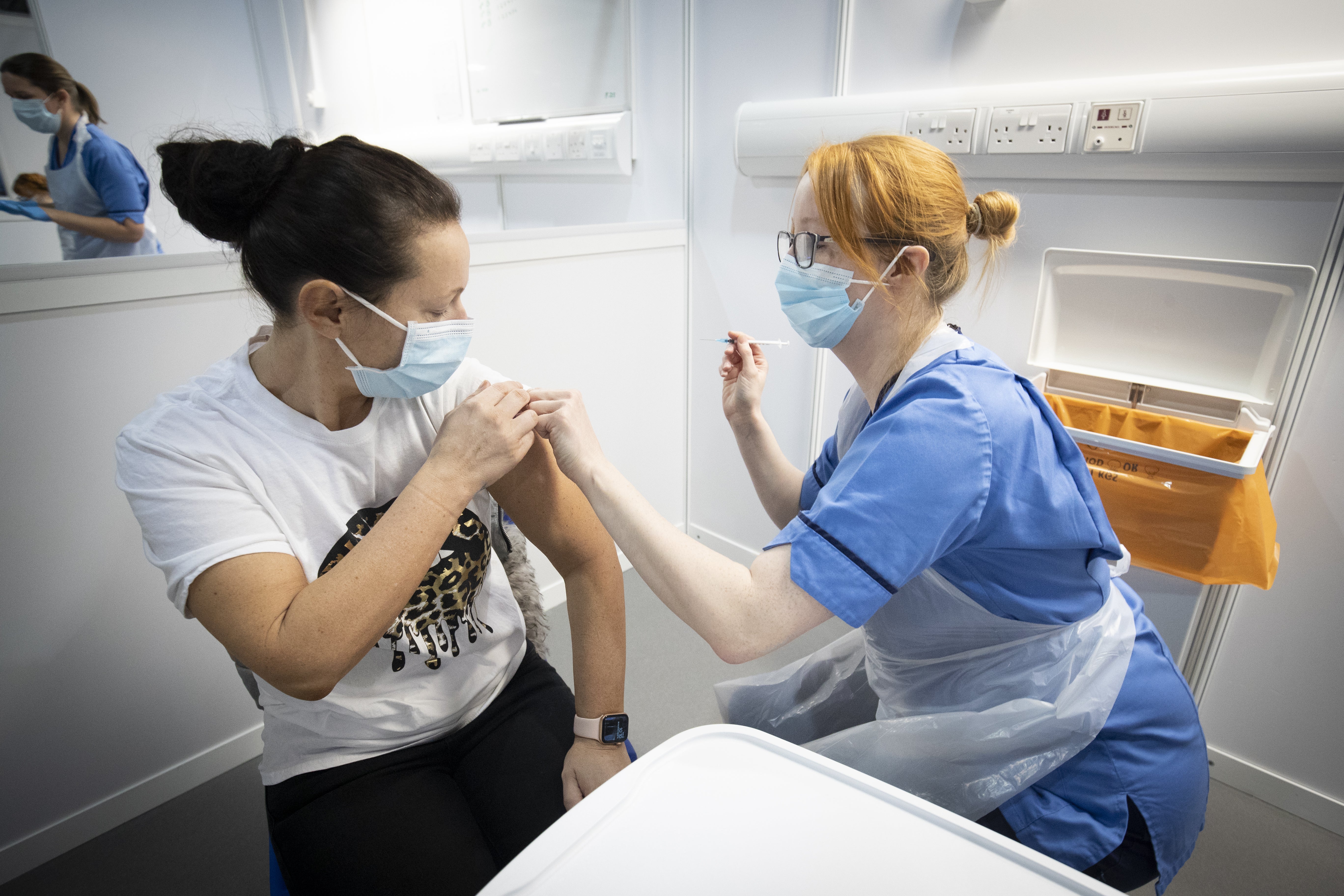Nurse Eleanor Pinkerton administers a coronavirus vaccine to one of the health and social care staff at the NHS Louisa Jordan Hospital in Glasgow (PA)