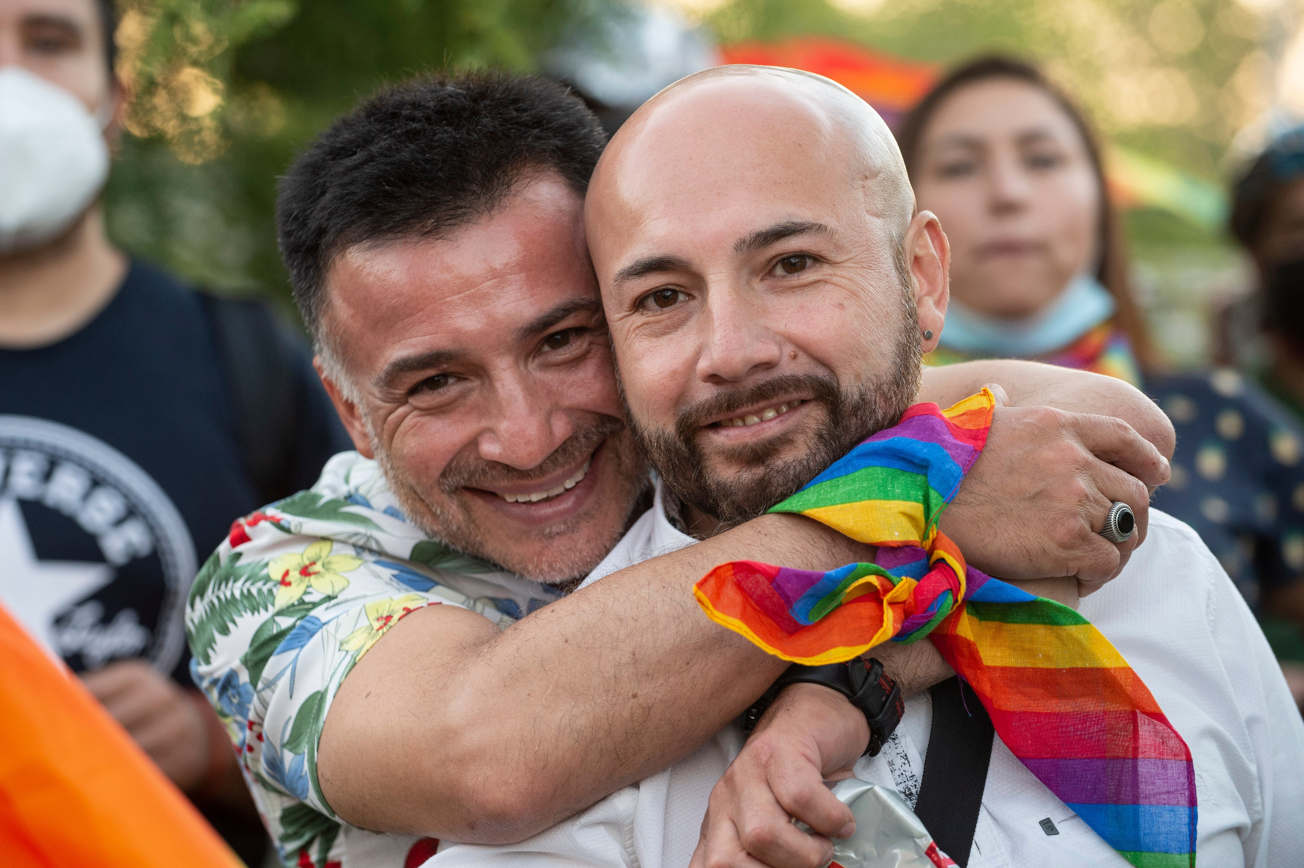 A couple smile during a rally after the bill for same-sex marriage was approved by the Chilean senate