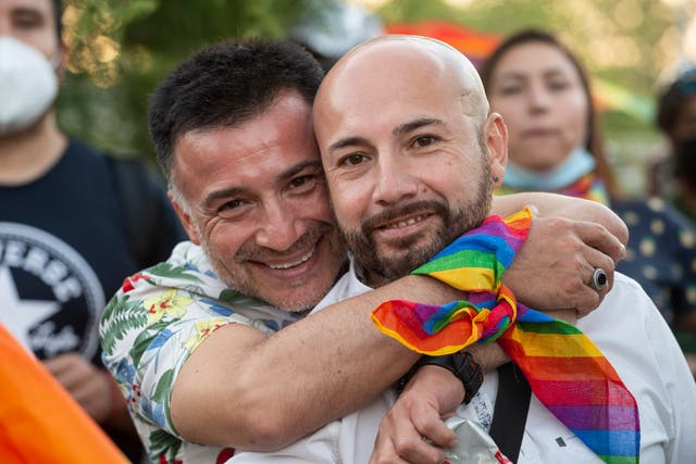 <p>A couple smile during a rally after the bill for same-sex marriage was approved by the Chilean senate </p>