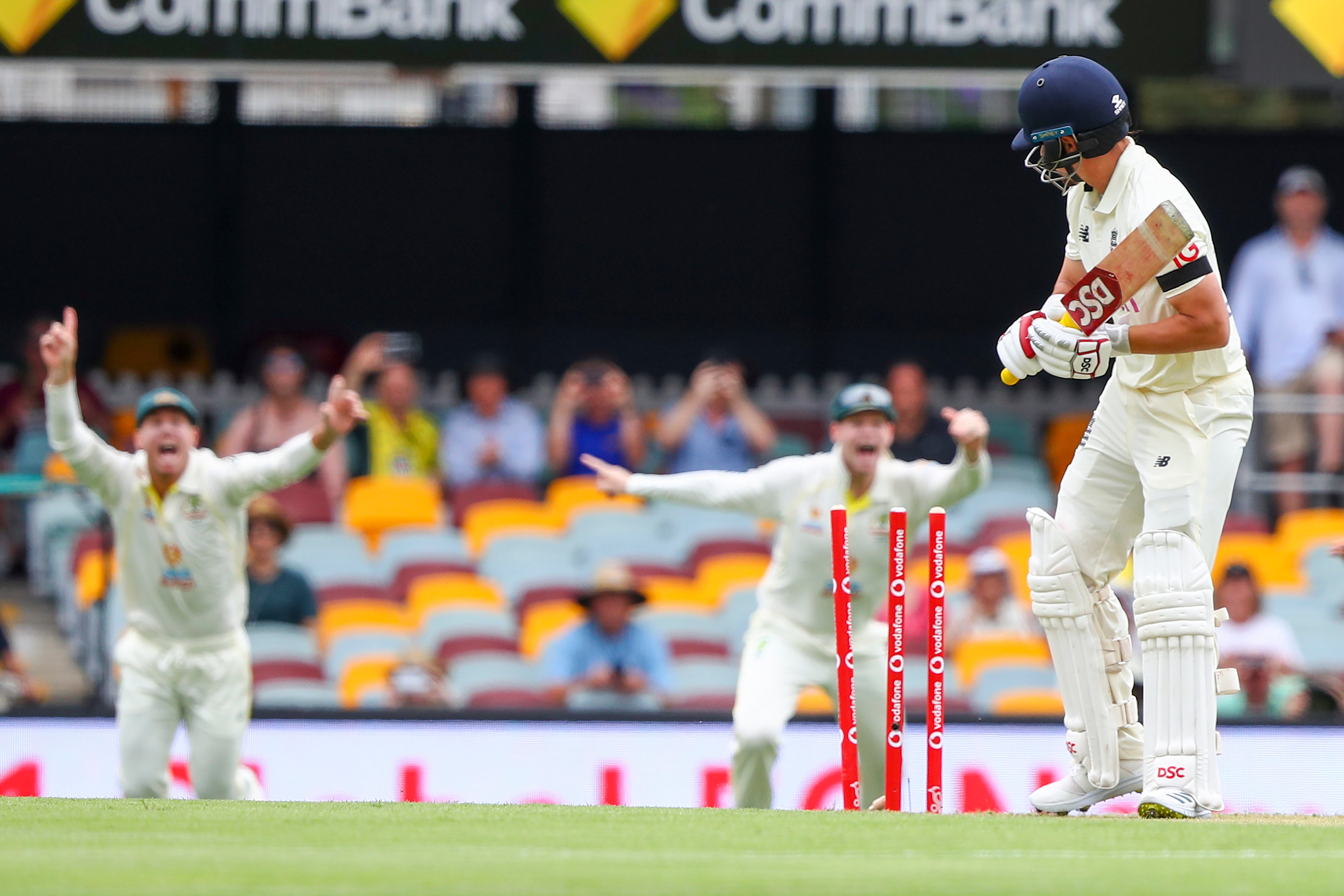 Rory Burns inspects his broken wicket after being bowled first ball