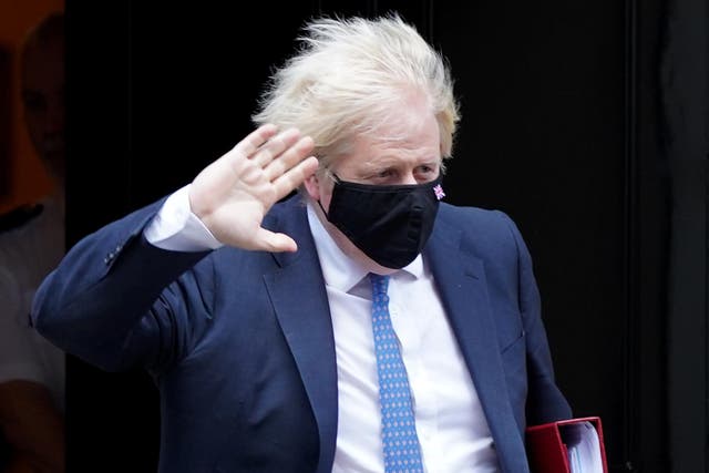 <p>Prime Minister Boris Johnson leaves 10 Downing Street, London, to attend Prime Minister’s Questions at the Houses of Parliament (PA)</p>
