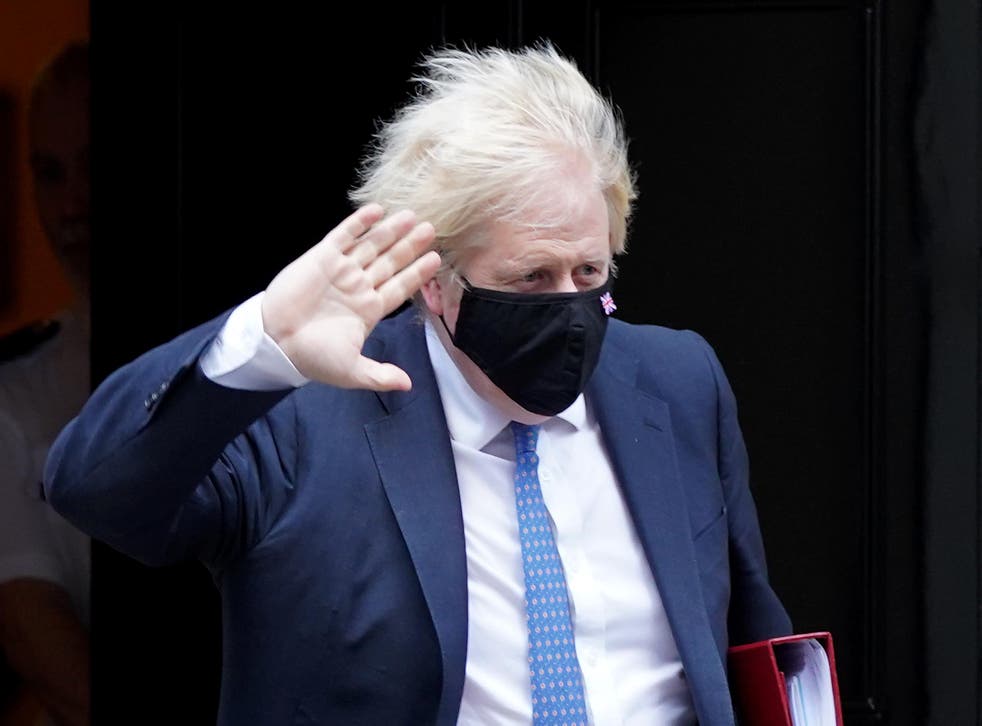<p>Prime Minister Boris Johnson leaves 10 Downing Street, London, to attend Prime Minister’s Questions at the Houses of Parliament (PA)</p>