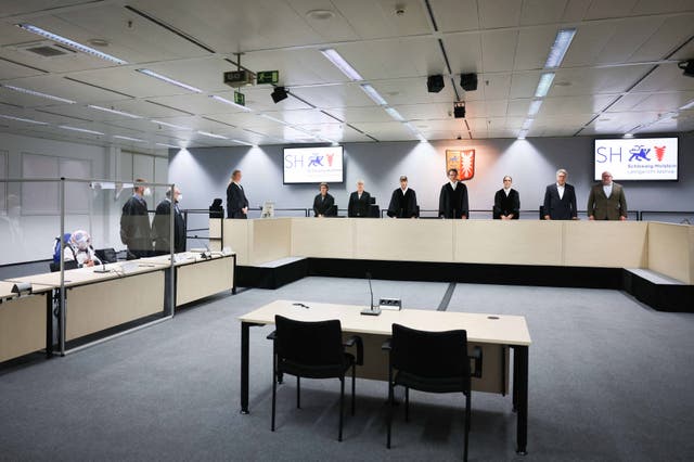 <p>File: 96-year-old defendant Irmgard F. (L), a former secretary for the SS commander of the Stutthof concentration camp, sits in the courtroom next to her lawyers Niklas Weber (2ndL) and Wolf Molkentin (3rdL), as the presiding judge Dominik Gross (4thR) and his team stand at the start of her trial   at the courtroom in Itzehoe, northern Germany, on 19 October 2021</p>