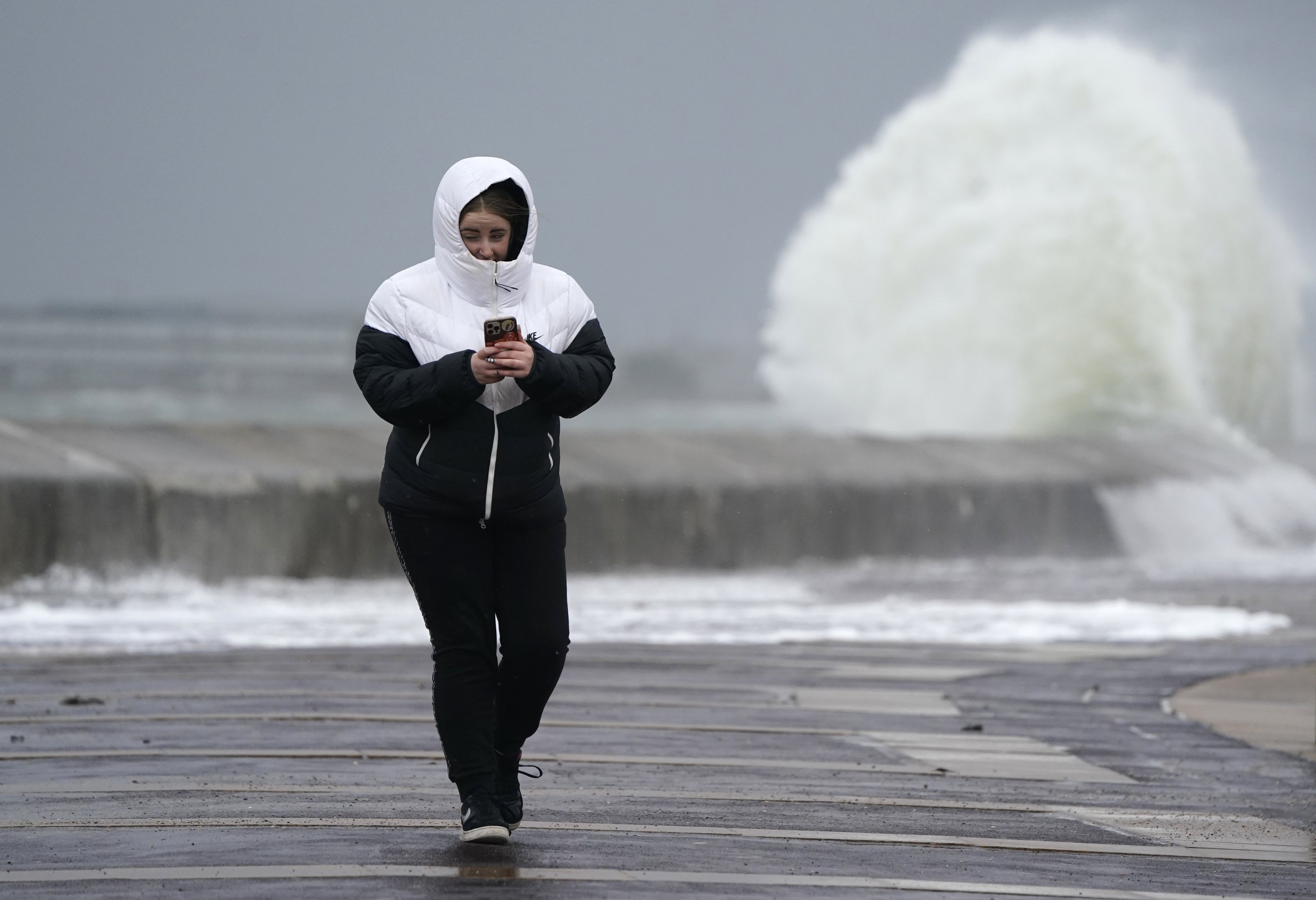 A person makes their way along the sea front in Southsea (Andrew Matthews/PA)