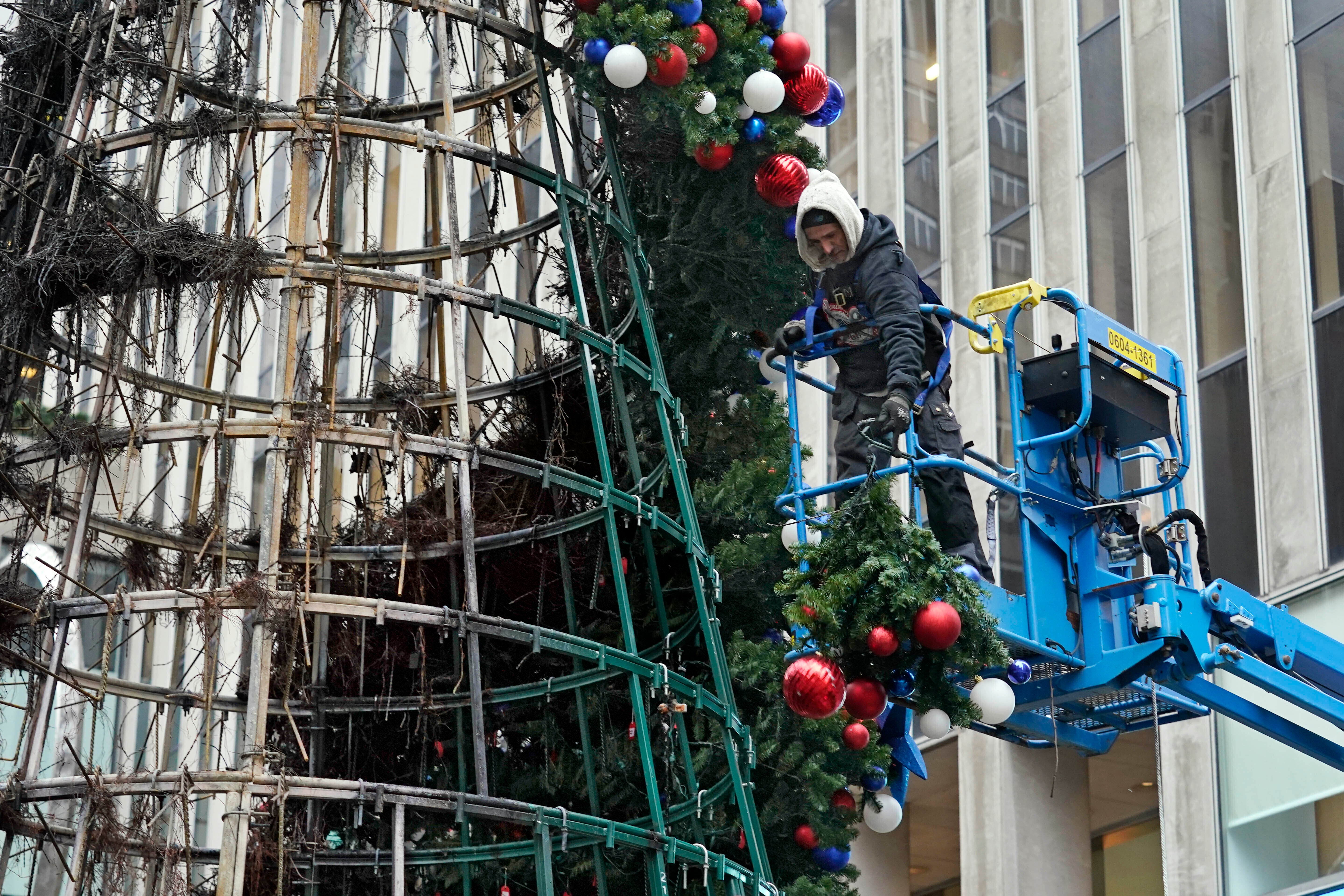 A worker disassembles the Fox Christmas tree