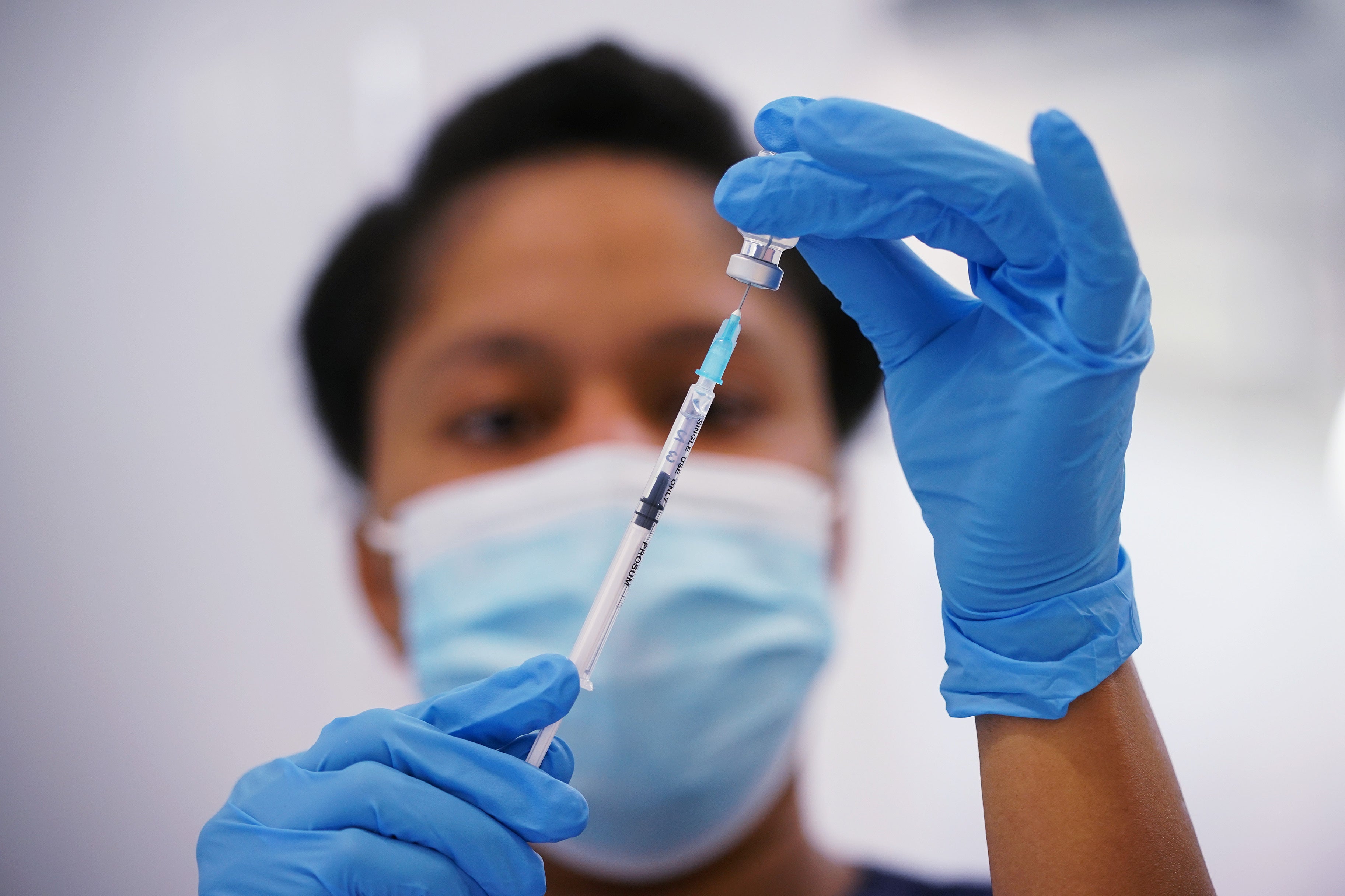 A nurse prepares a dose of the Pfizer Covid-19 vaccination at a vaccination site in Liberty Shopping Centre, Romford, east London (Yui Mok/PA)