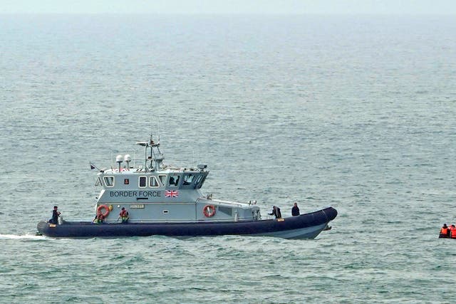 <p>A Border Force vessel approaches a group of people in the Channel (Gareth Fuller/PA)</p>