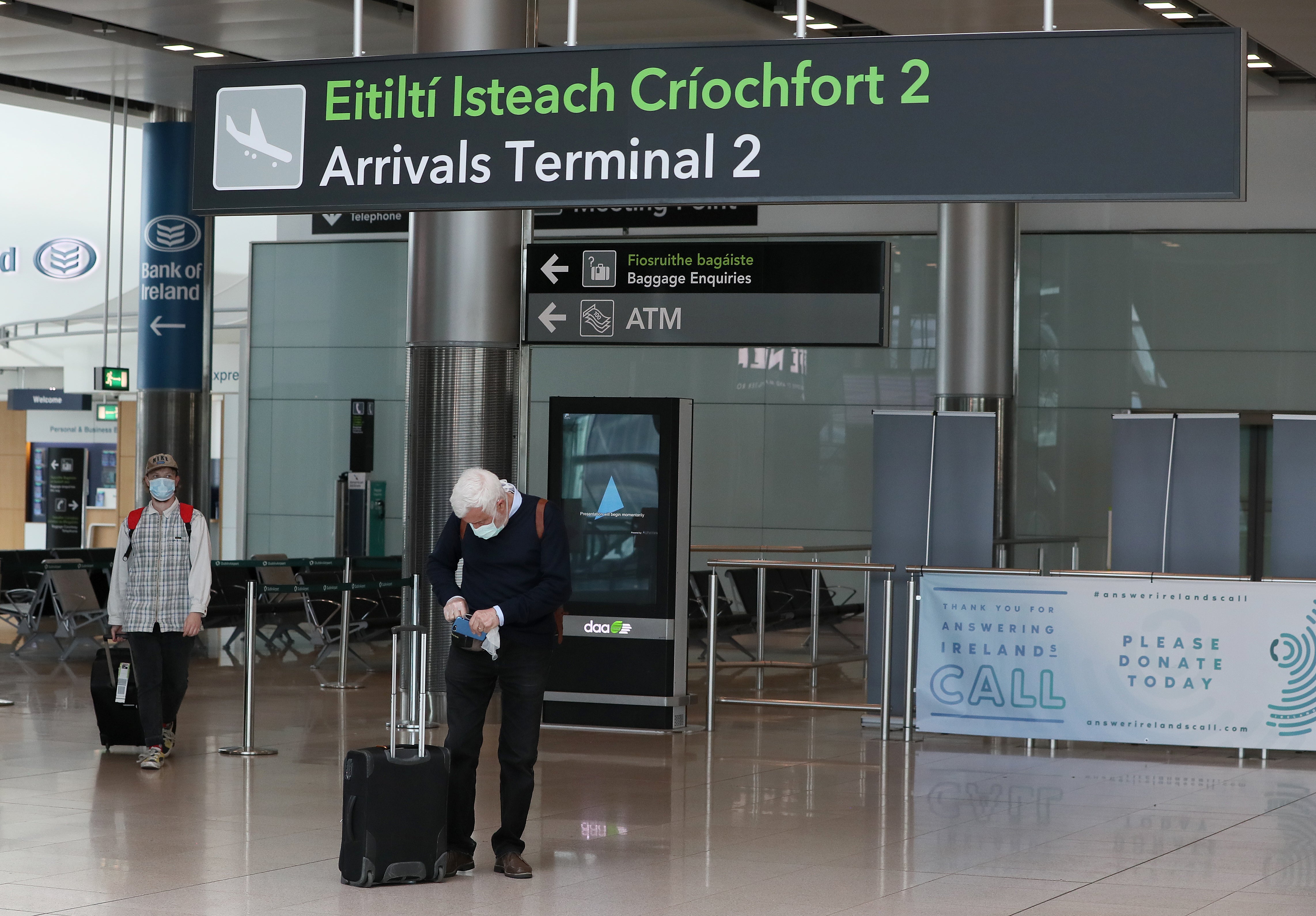 People wearing protective face masks in Terminal 2 at Dublin Airport (Brian Lawless/PA)
