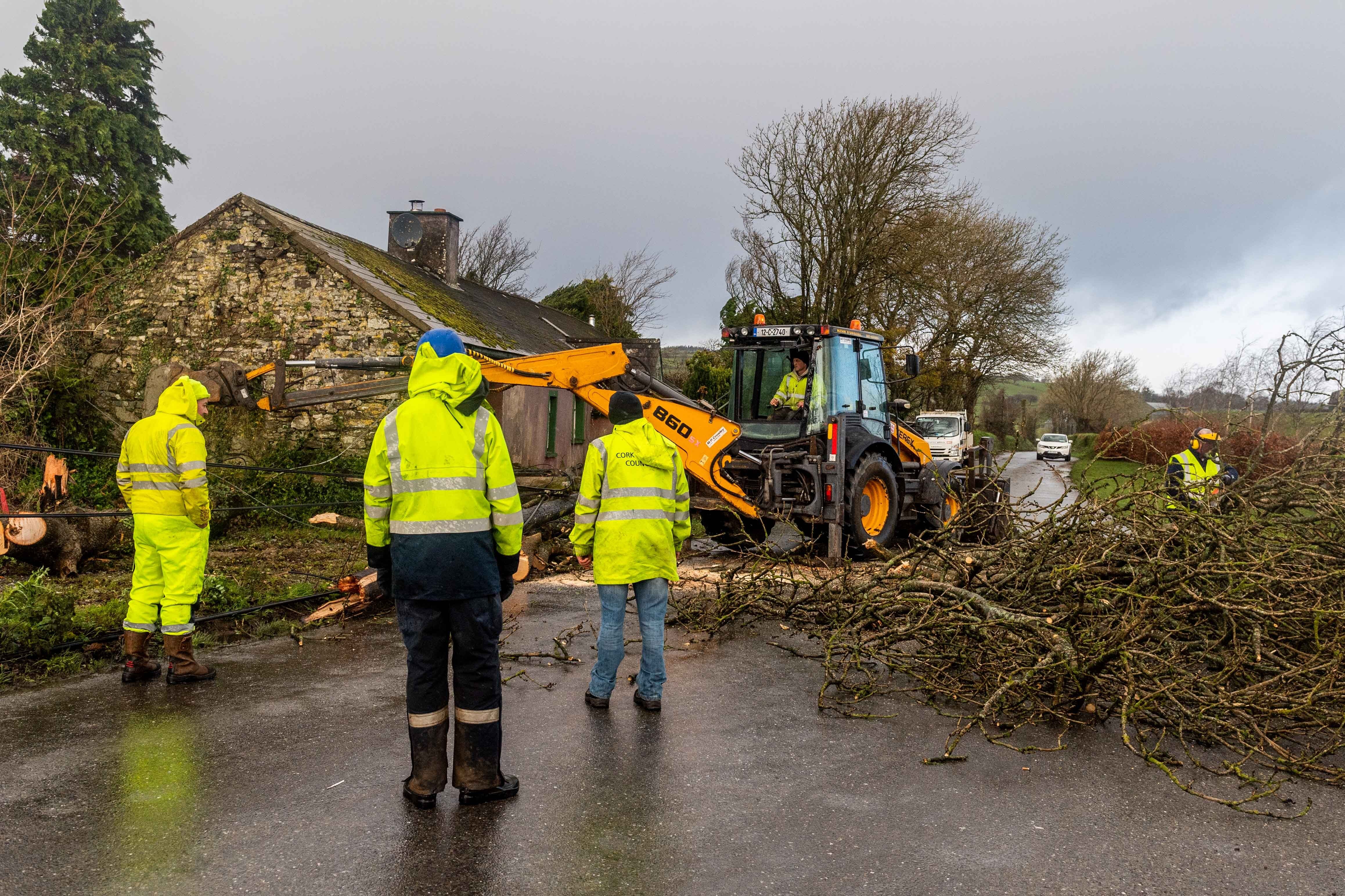 Workmen clear storm debris from roads in West Cork (Andy Gibson/PA)