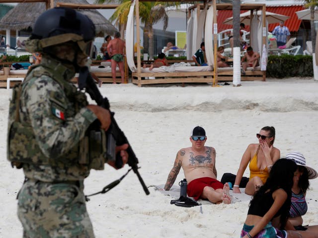 <p>A member of the Navy patrols a beach resort as part of the vacation security in the tourist zone in Cancun by the government of Quintana Roo, Mexico December 5, 2021. REUTERS/Paola Chiomante NO RESALES. NO ARCHIVES     REFILE - CORRECTING FORCE</p>