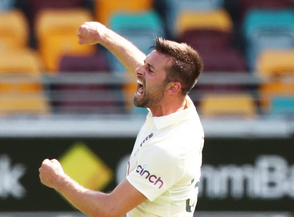 England’s Mark Wood celebrates the wicket of Australia’s Steve Smith during day two of the first Ashes test at The Gabba, Brisbane (Jason O’Brien/PA)