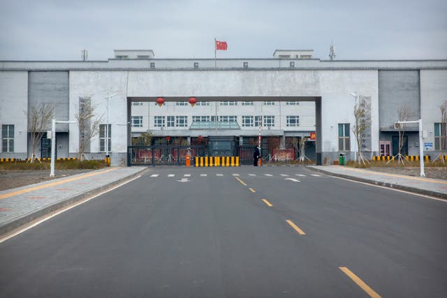 <p>Police officers stand at the outer entrance of the Urumqi No. 3 Detention Center in Dabancheng in western China's Xinjiang Uyghur Autonomous Region</p>