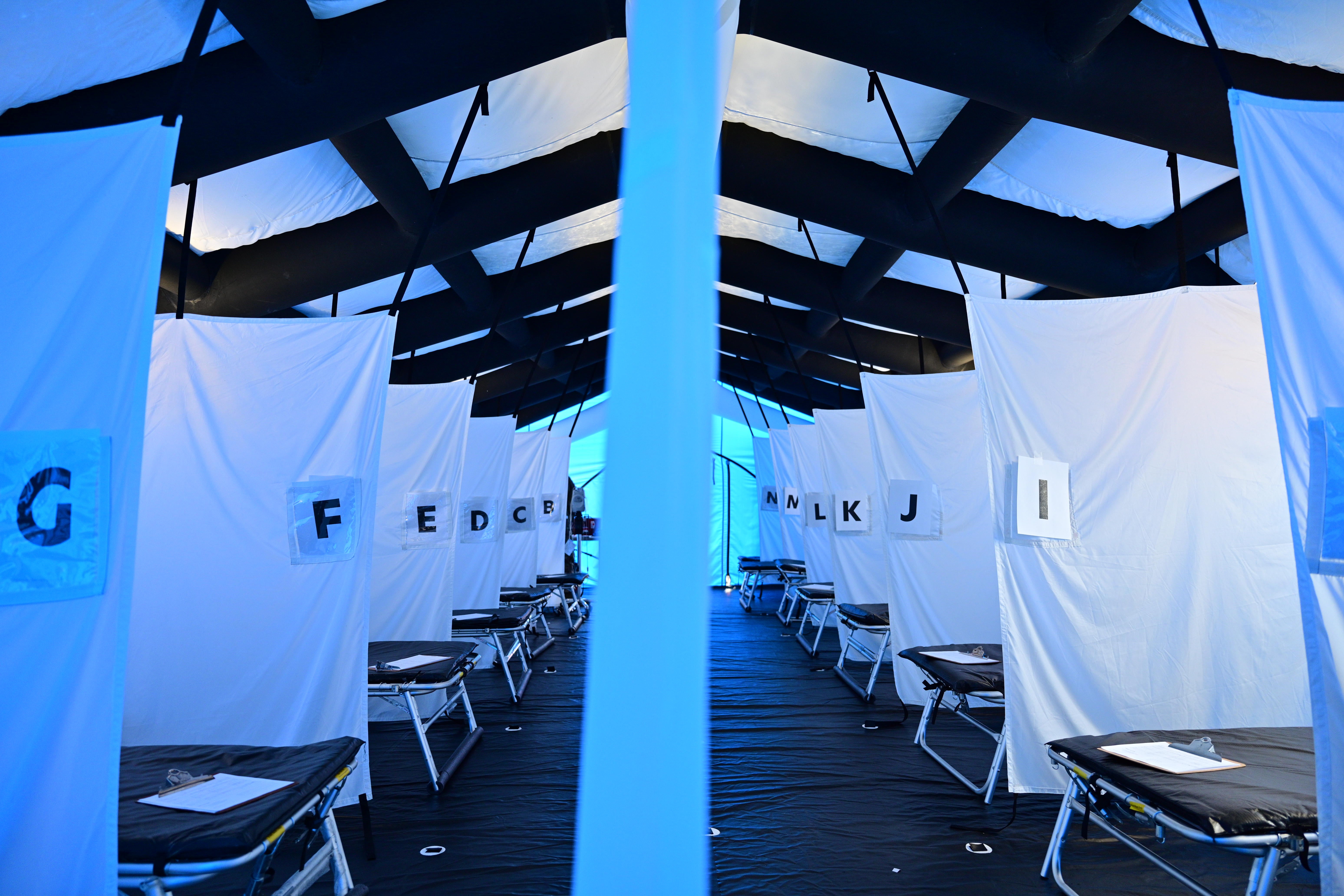 Rows of beds and their letter designations are seen in a tent used for monoclonal antibody treatment of COVID-19 patients outside of St. Claire Regional Medical Center on September 16, 2021 in Morehead, Kentucky.
