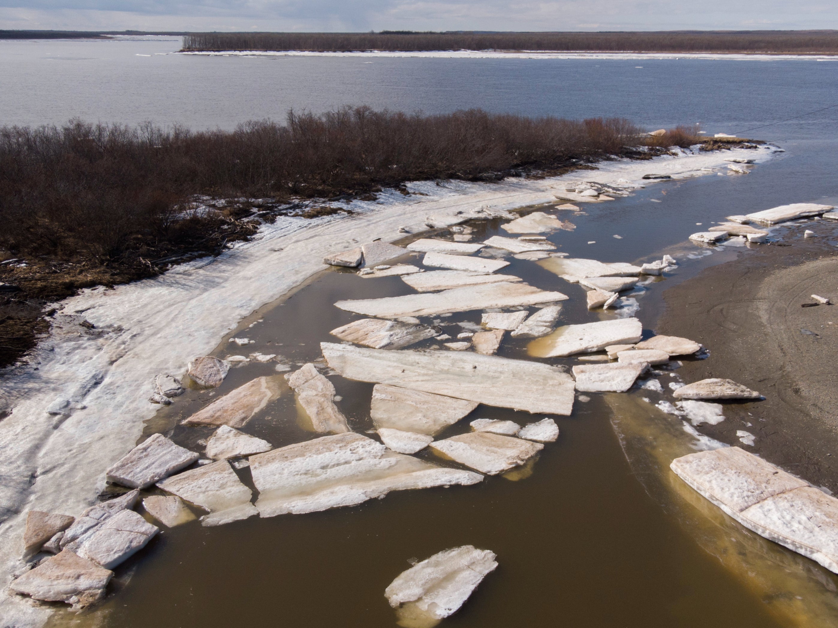 This file photo from 2019 shows melting ice beside severe erosion of the permafrost tundra at Bethel on the Yukon Delta in Alaska
