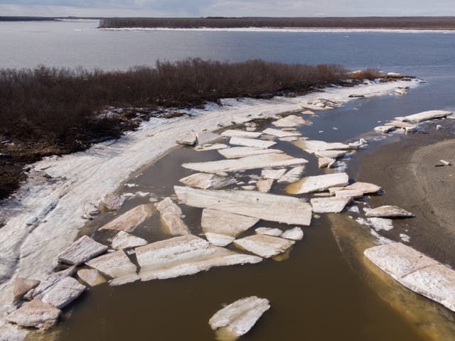 <p>This file photo from 2019 shows melting ice beside severe erosion of the permafrost tundra at Bethel on the Yukon Delta in Alaska </p>