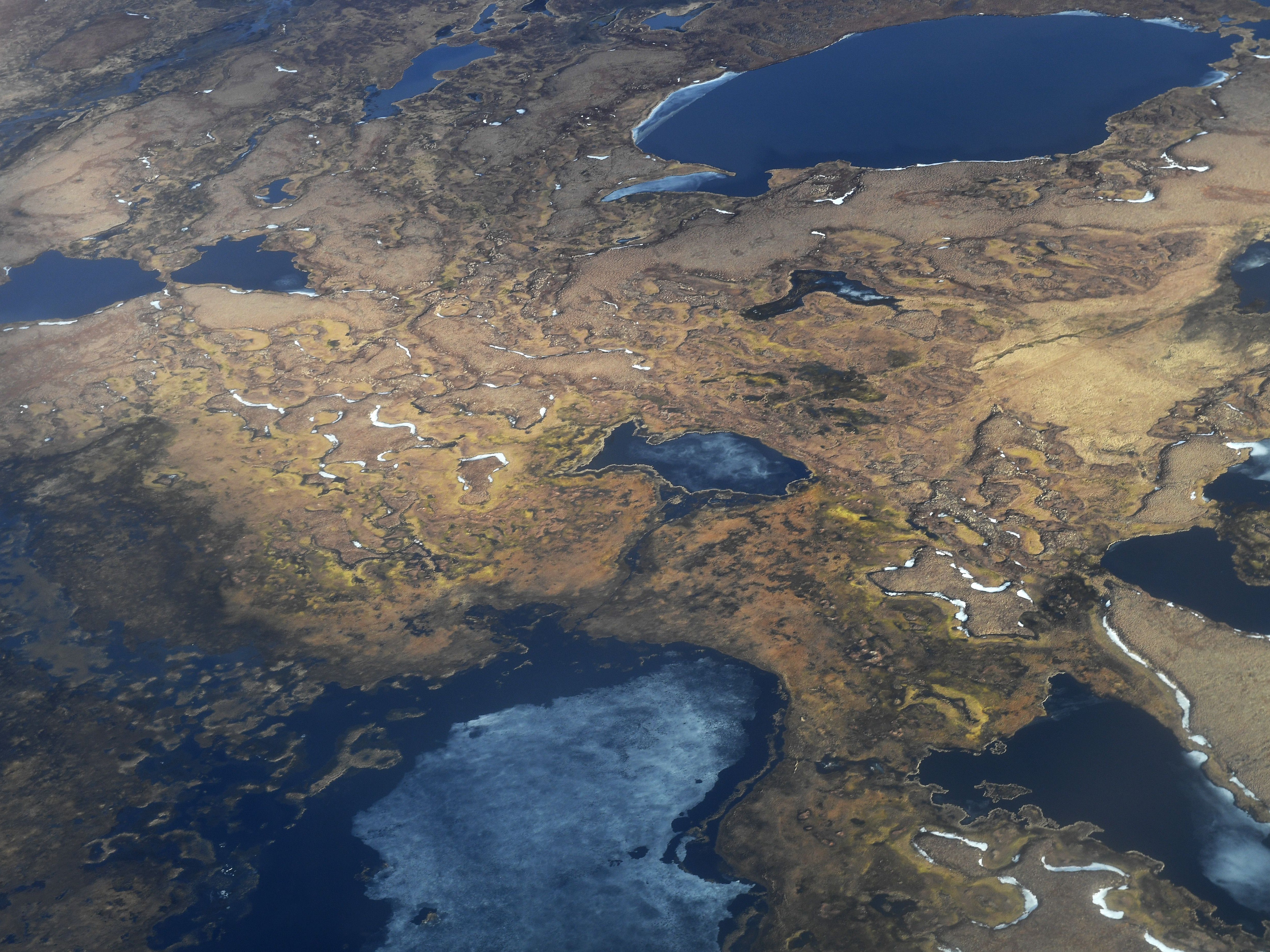 This file photo from 2019 shows an aerial view of melting permafrost tundra and lakes near the Yupik Eskimo village, of Quinhagak, on the Yukon Delta in Alaska