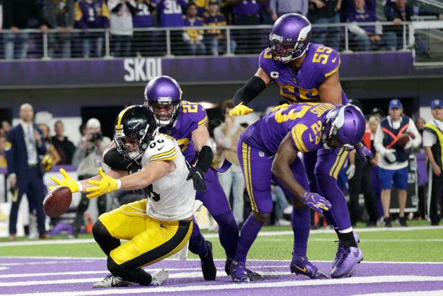 Minnesota Vikings defenders safety Harrison Smith (22), outside linebacker Anthony Barr (55) and free safety Xavier Woods (23) break up a pass intended for Pittsburgh Steelers tight end Pat Freiermuth (88) in the end zone at the end of an NFL football game (AP Photo/Andy Clayton-King)