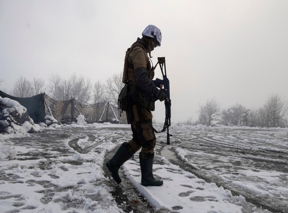 <p>A Ukrainian soldier walks at the line of separation from pro-Russian rebels near Popasna, Donetsk region, Ukraine, Tuesday, 7 December 2021.</p>