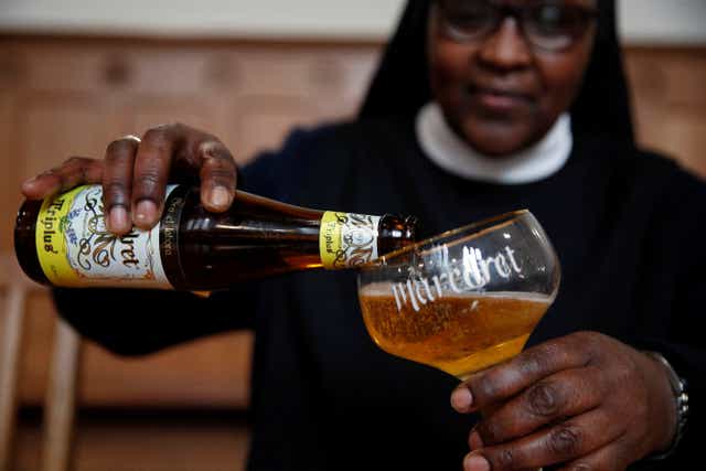 <p>Benedictine Sister Gertrude drinks a ‘Maredret’ beer</p>