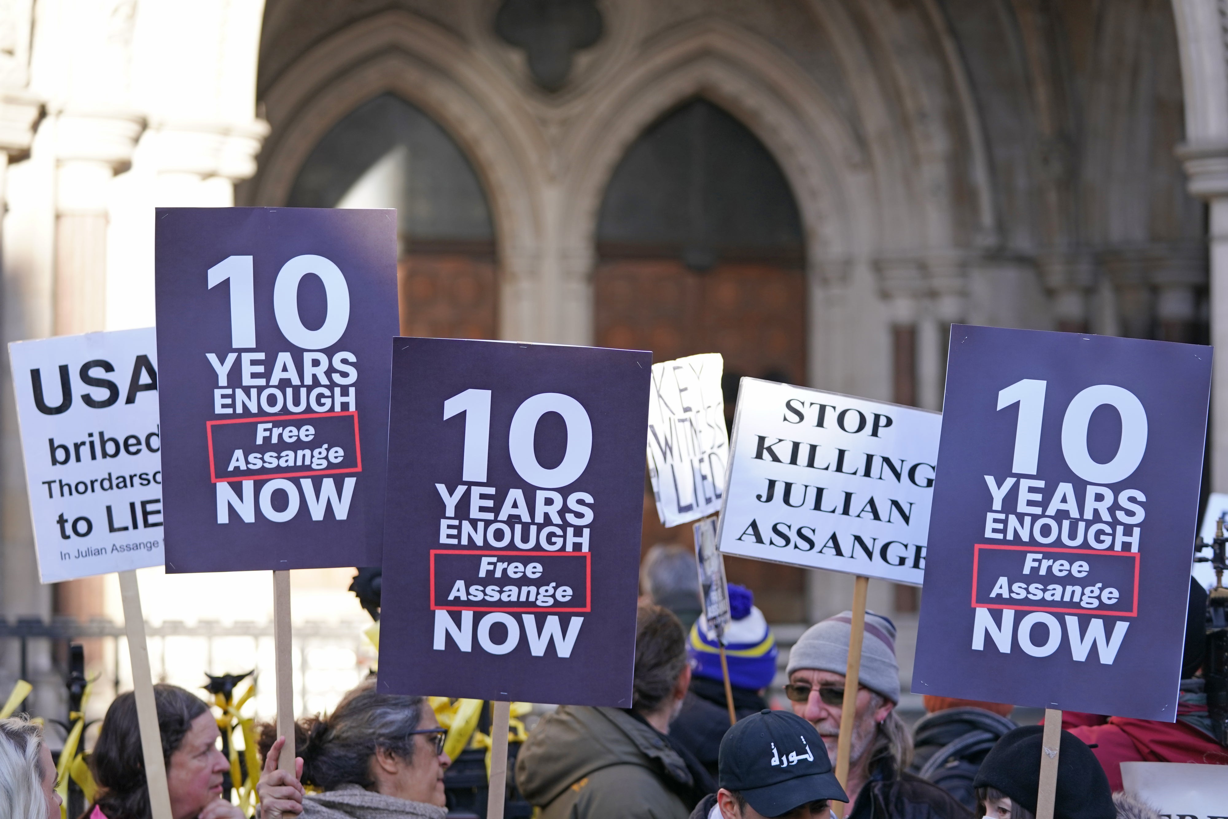 Supporters of Julian Assange demonstrate outside the Royal Courts of Justice (PA)
