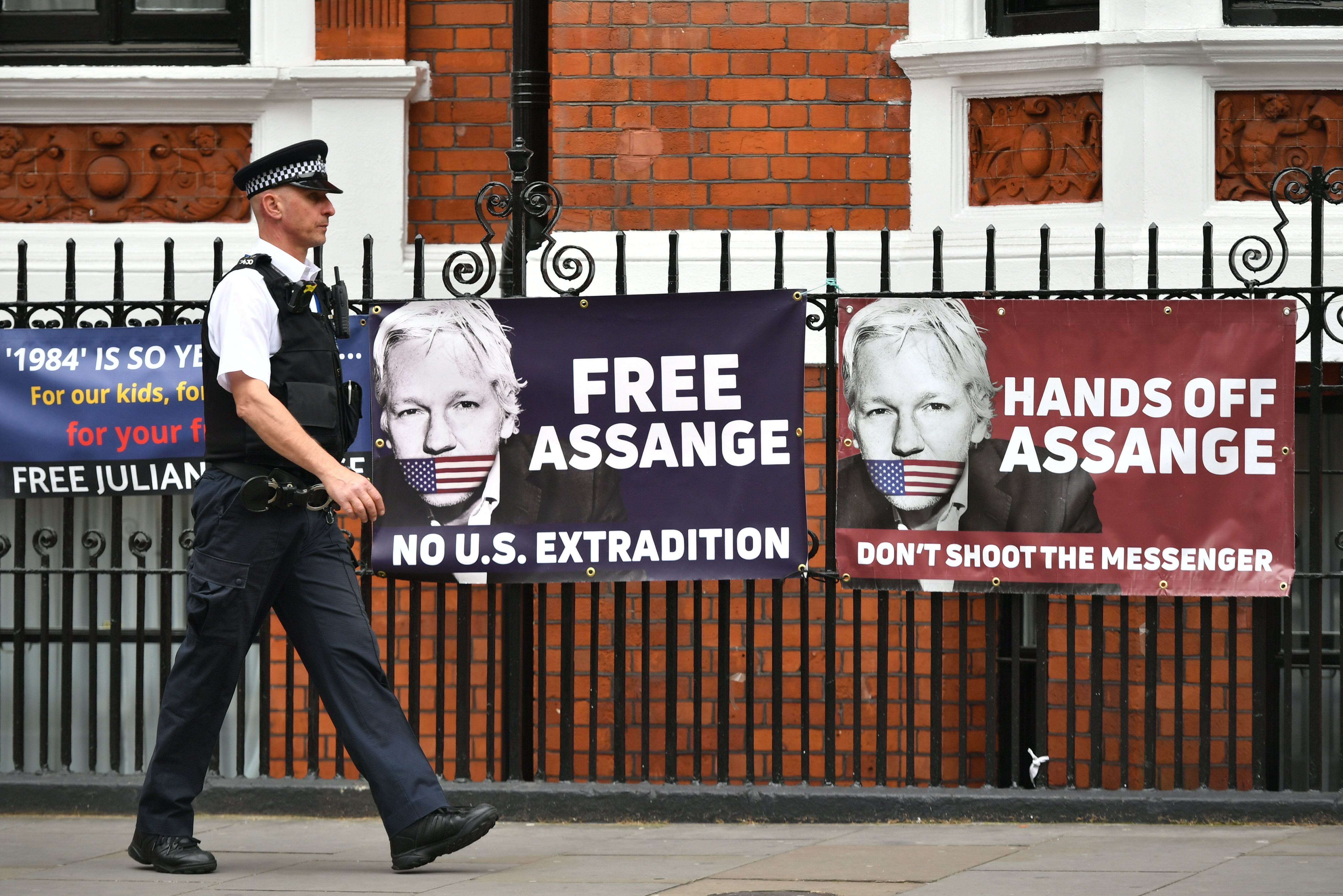 A police officer walks past the Ecuadorian embassy in London (Dominic Lipinski/PA)