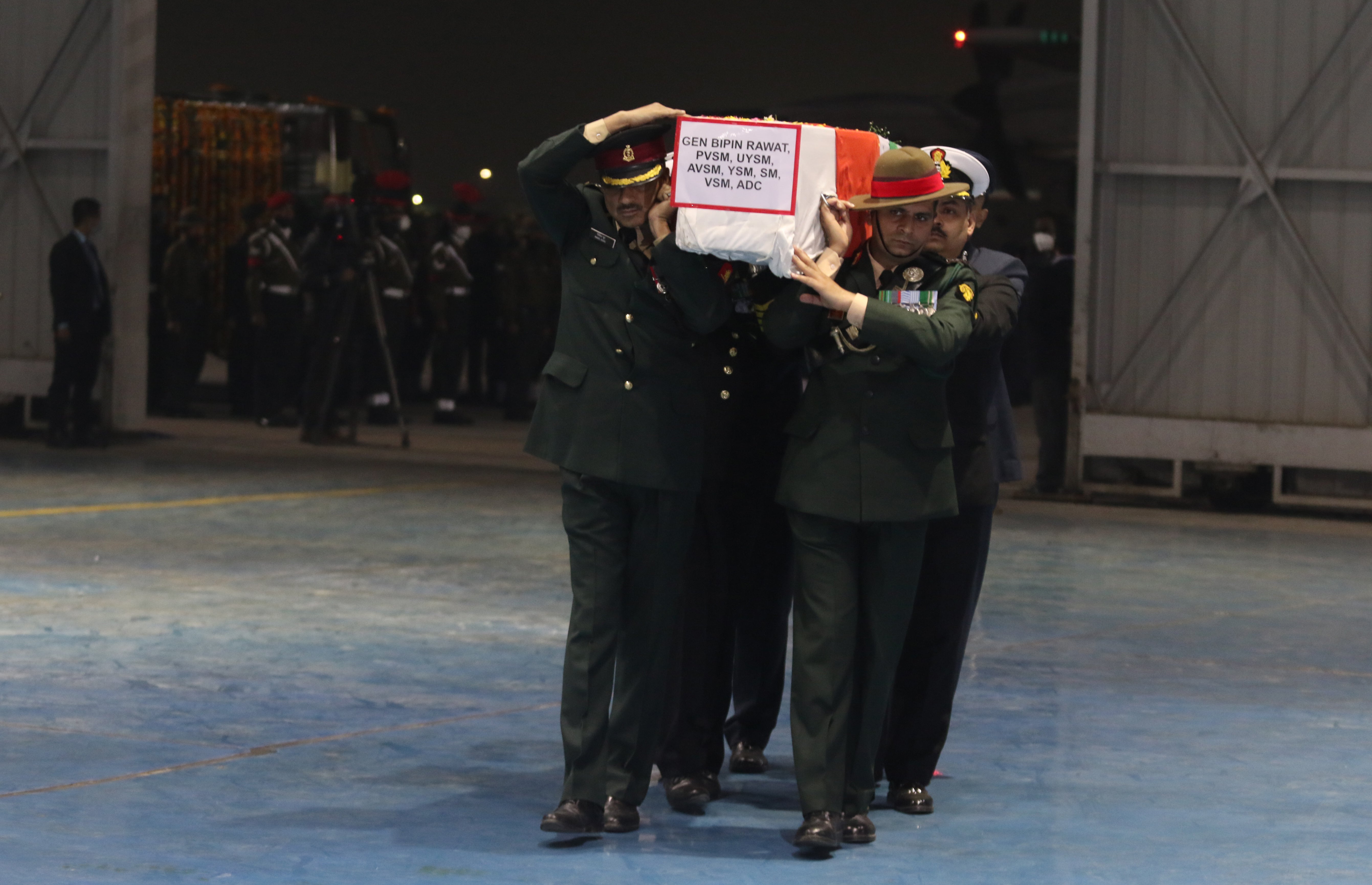Army officers carry the coffins containing the mortal remains of India’s defence chief General Bipin Rawat