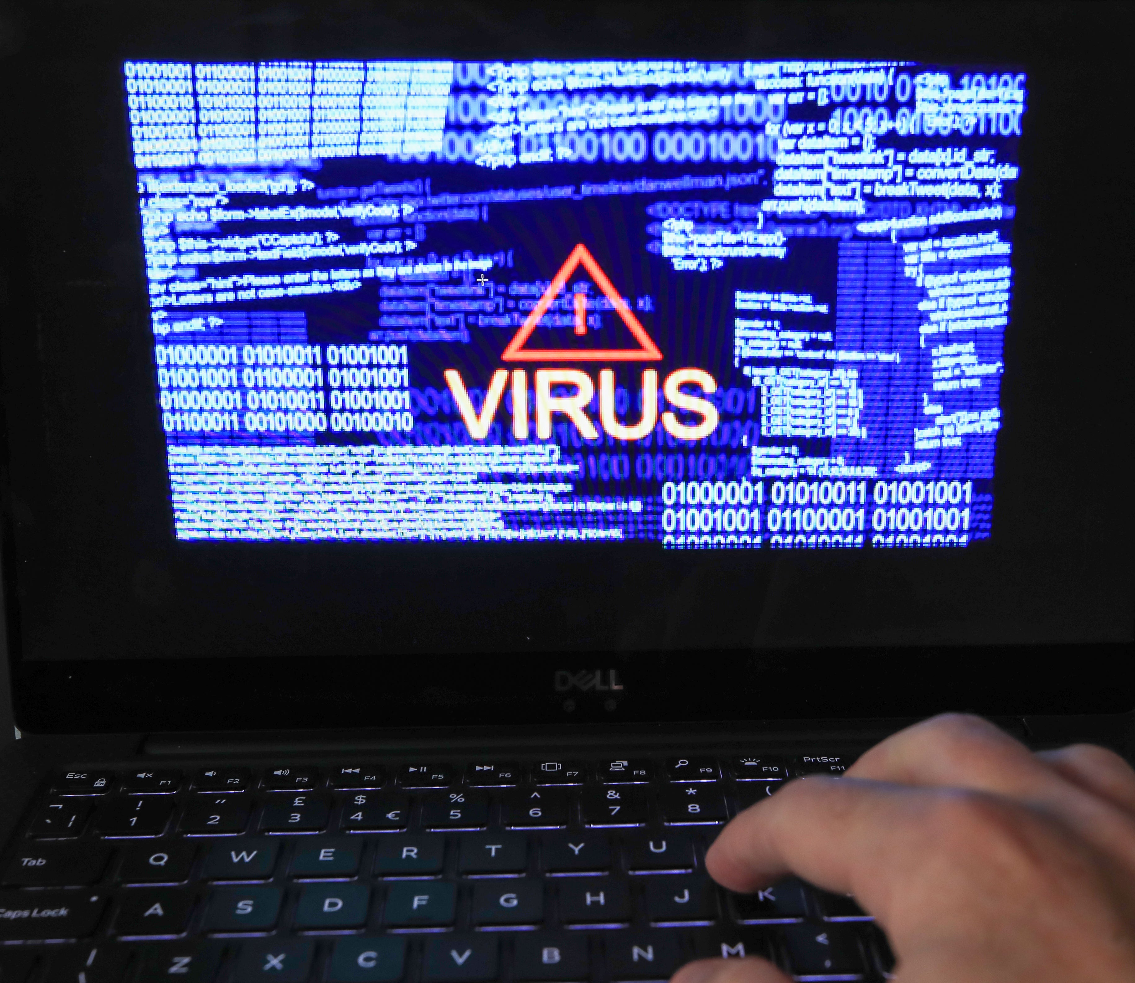 A laptop screen shows a computer virus warning (Peter Byrne/PA)