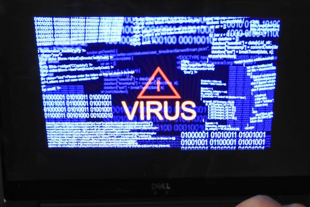 A laptop screen shows a computer virus warning (Peter Byrne/PA)