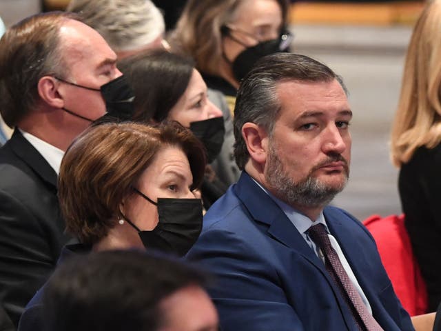 <p>US senators Ted Cruz (R) and Amy Kobluchar attend the funeral service for former US Senator Bob Dole at the Washington National Cathedral, on December 10, 2021, in Washington, DC</p>