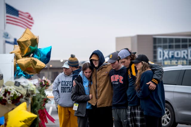 <p>Students comfort each other at a memorial outside Oxford High School in Michigan where four students were killed in the most recent mass shooting at a US school</p>