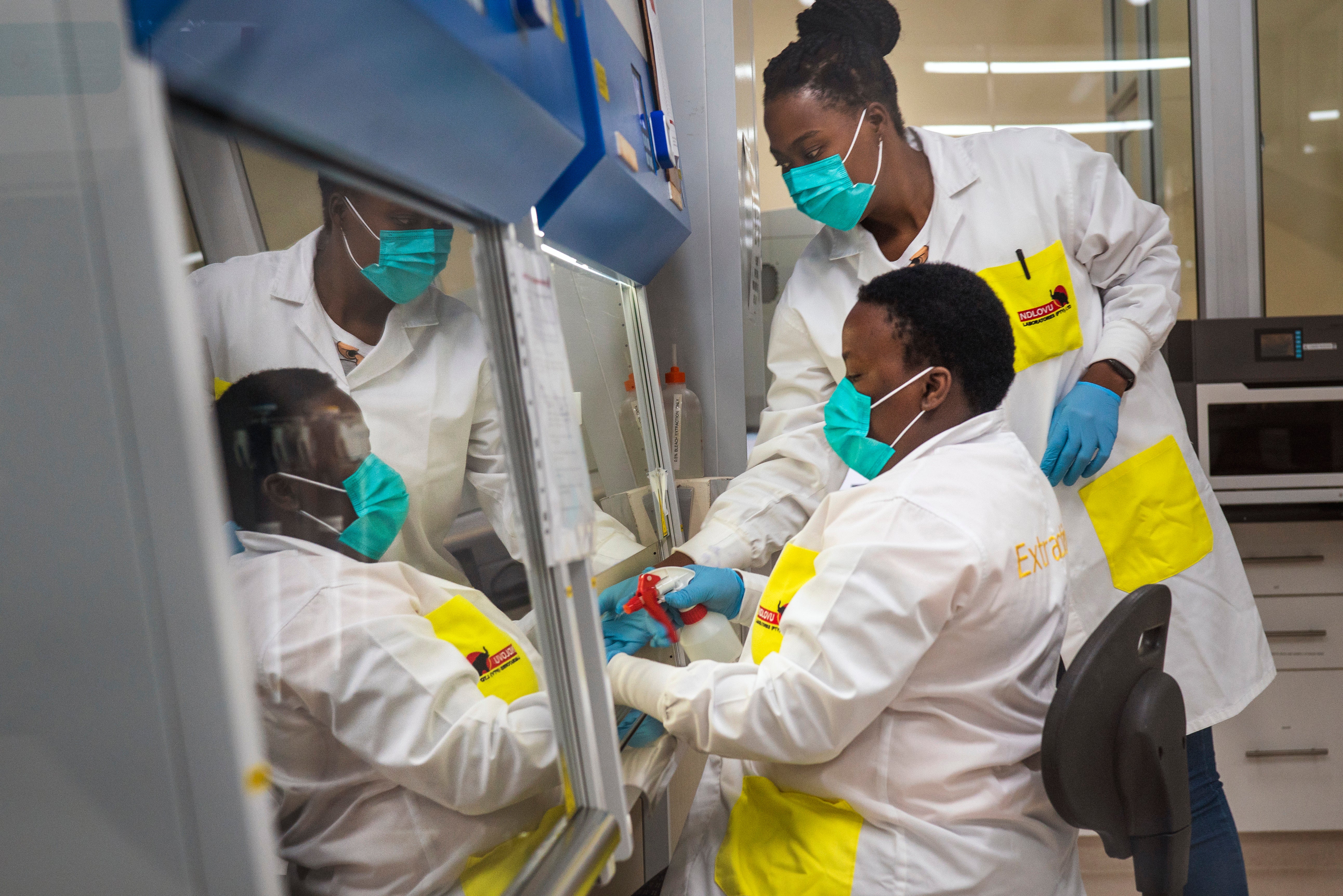 Medical scientists Melva Mlambo, right, and Puseletso Lesofi, preparing to sequence Covid omicron samples at the Ndlovu Research Center in South Africa