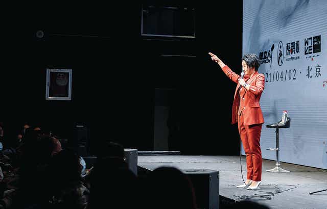 <p>Comedian Xiaolu performs in an open-mic session</p>