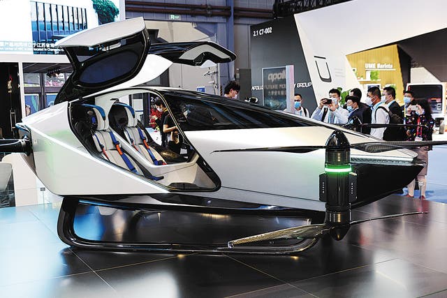 <p>Visitors look over the X2 flying car, produced by Chinese company XPeng, that is on display at the China International Import Expo held in Shanghai in November</p>