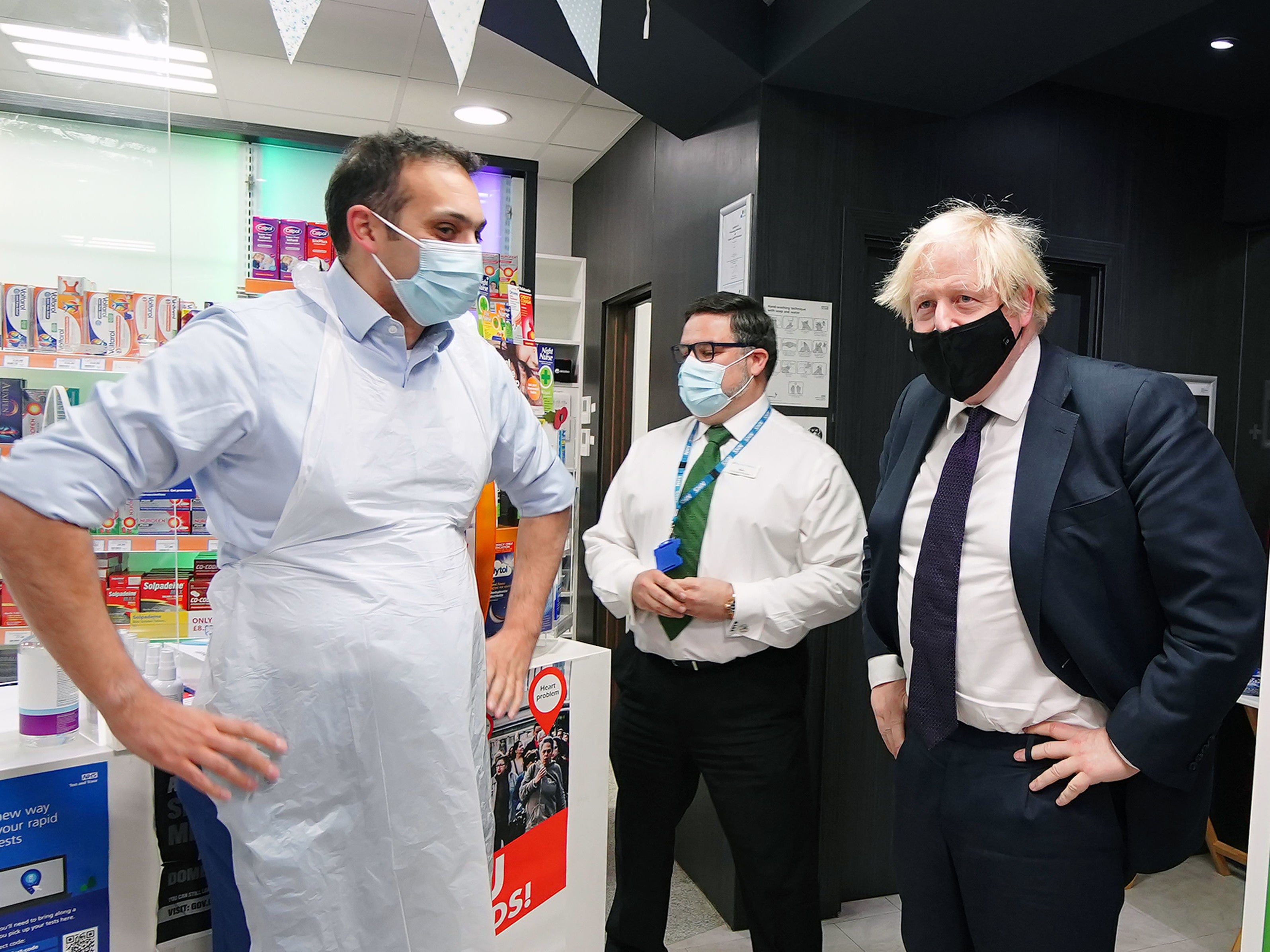 Boris Johnson meets staff during a visit to a pharmacy in North Shropshire ahead of the upcoming by-election