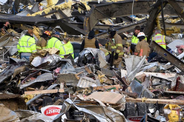 <p>Emergency workers search what is left of the Mayfield Consumer Products Candle Factory after it was destroyed by a tornado in Mayfield, Kentucky, on December 11, 2021</p>