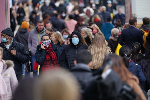 People wearing face masks walking along Oxford Street, London (PA)