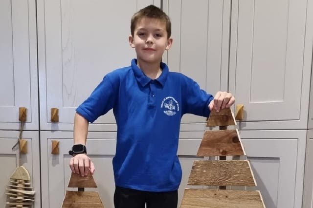 Nine-year-old entrepreneur Noah Last is brightening up his village in Suffolk by selling hand-crafted wooden Christmas trees (Michelle Last/PA)