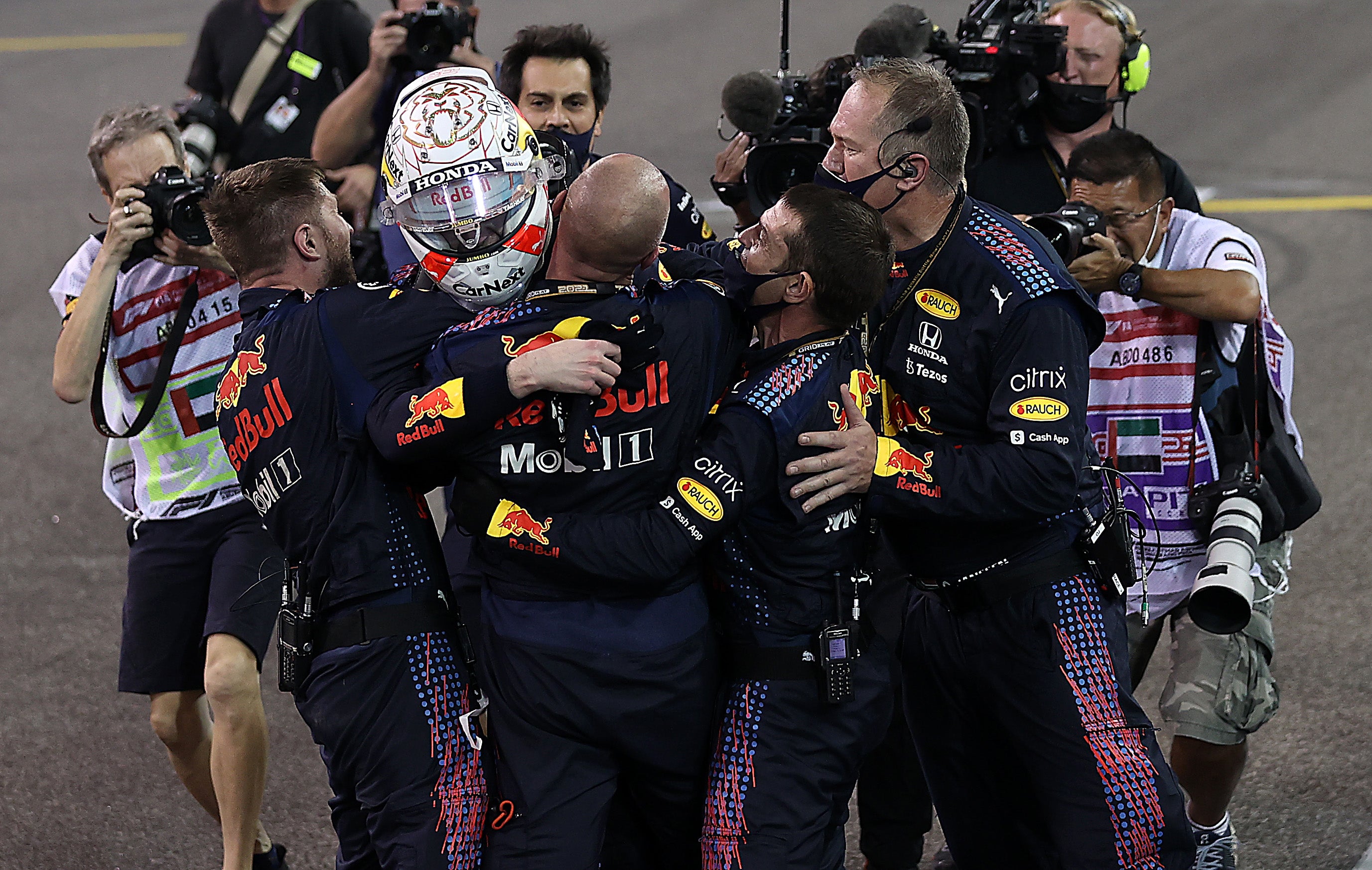 Verstappen is mobbed by his Red Bull team after crossing the line