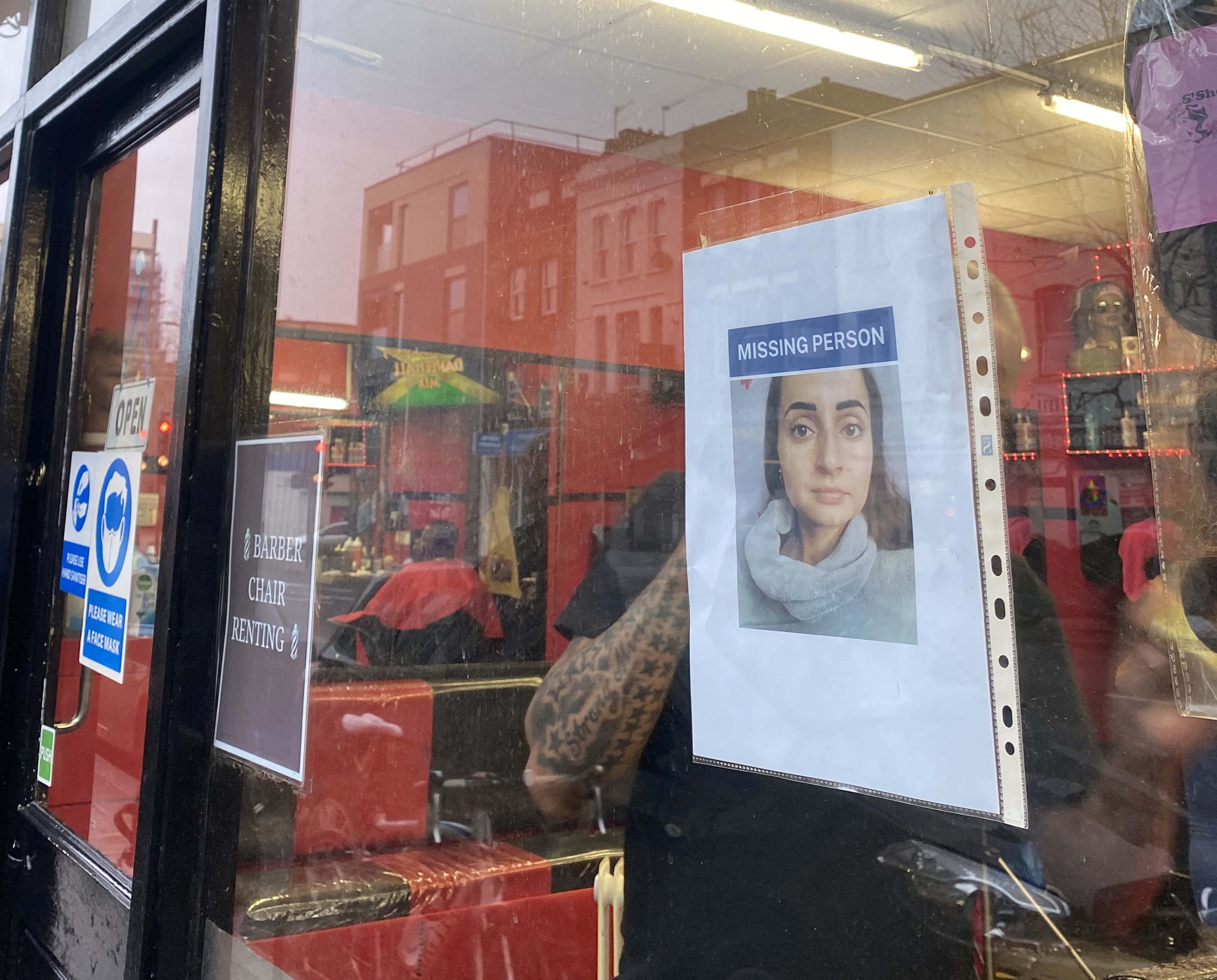 A missing poster being placed in the window of a shop in the Camberwell area of London of Petra Srncova, who has been missing for a week (Sophie Corcoran/PA)