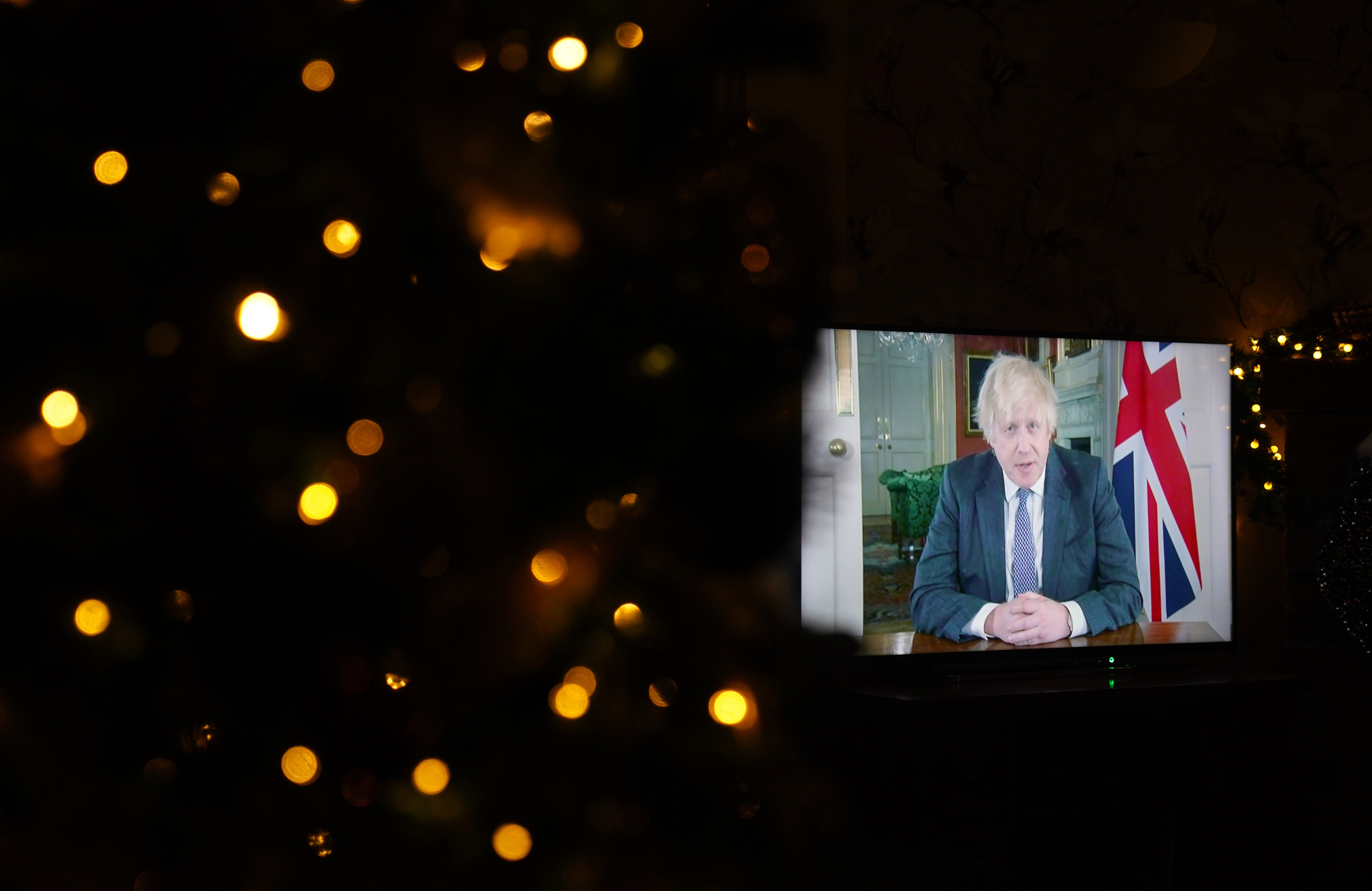 Prime Minister Boris Johnson appears on a TV screen during a pre-recorded address to the nation from Downing Street (Mike Egerton/PA)