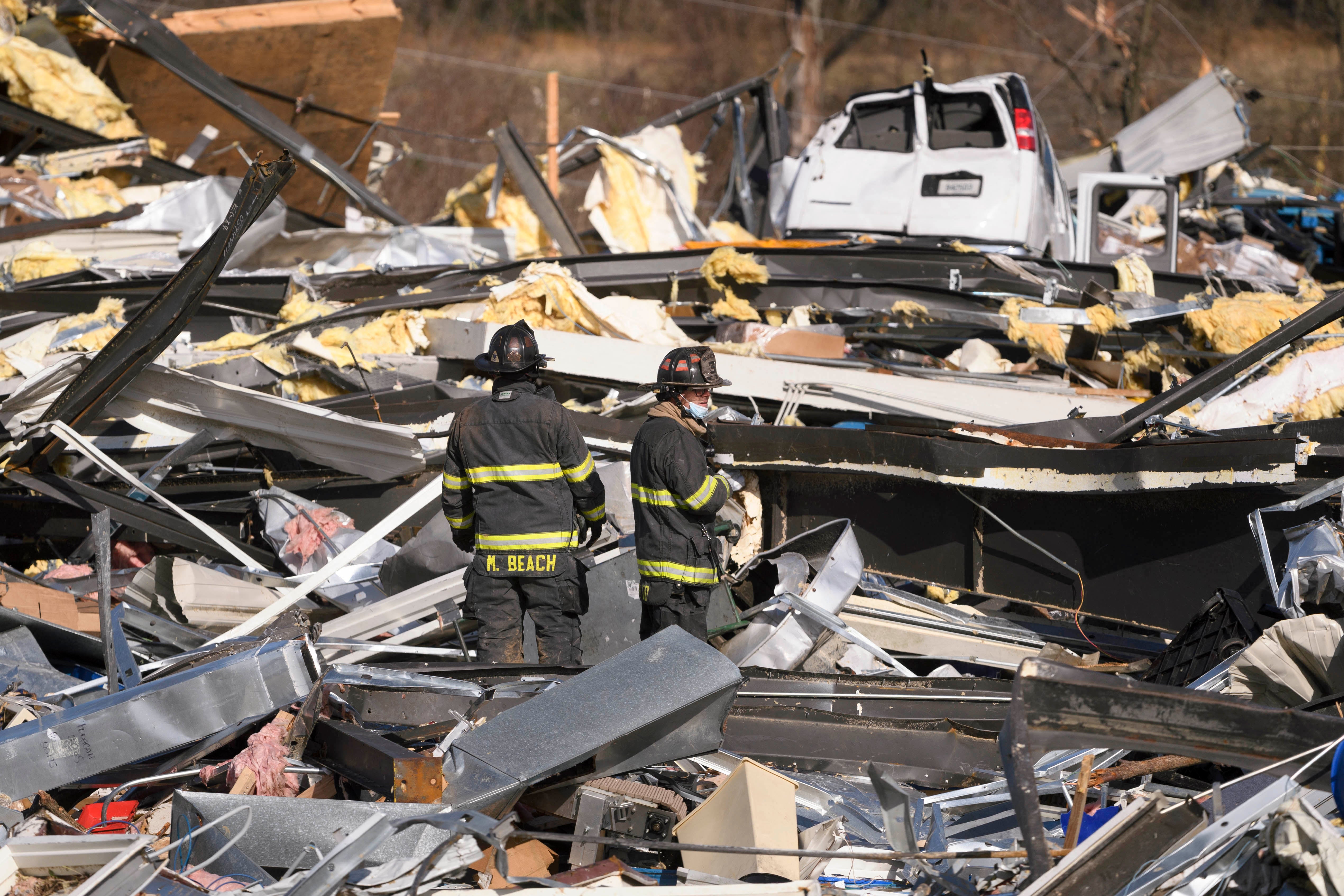 Emergency workers search through what is left of the Mayfield Consumer Products Candle Factory after it was destroyed by a tornado in Mayfield, Kentucky, on December 11, 2021.