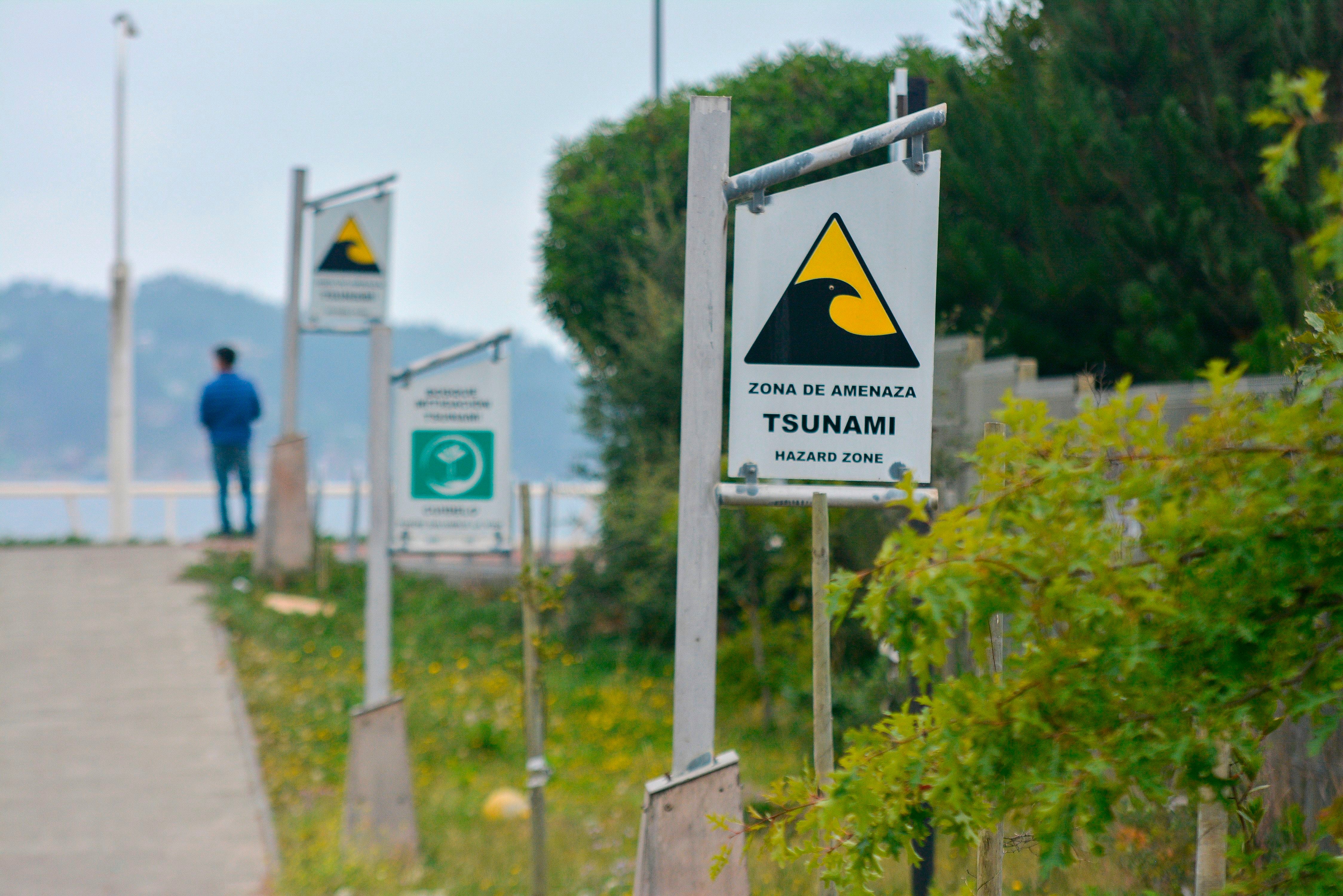 Signs in Dichato, Chile, 519kms (322 miles) south of Santiago de Chile, on February 24, 2020, direct resident to tsunami evacuation route