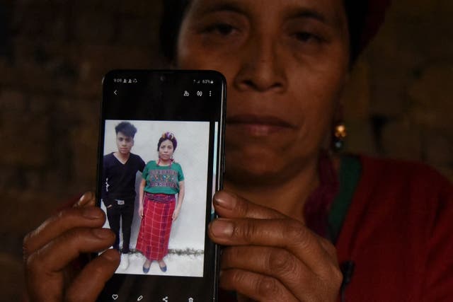 <p>Teresa Mateo shows a picture of her son Giovani Raymundo Mateo a Guatemalan who died in a truck crash in Mexico last week</p>