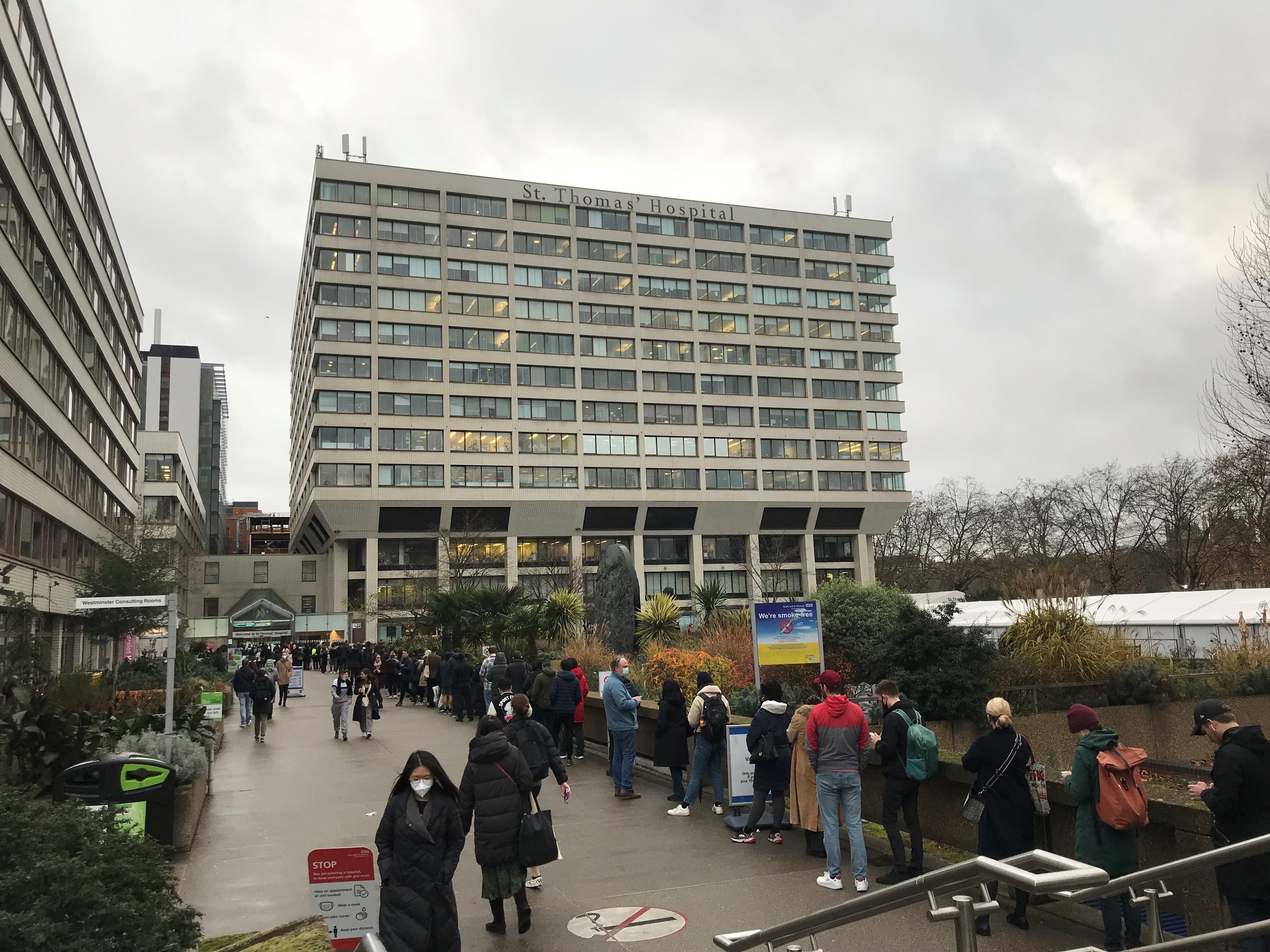 People queuing for booster jabs at St Thomas Hospital, London. Everyone over 18 in England will be offered booster jabs from this week, the PM said on Sunday, as he declared an ‘omicron emergency’