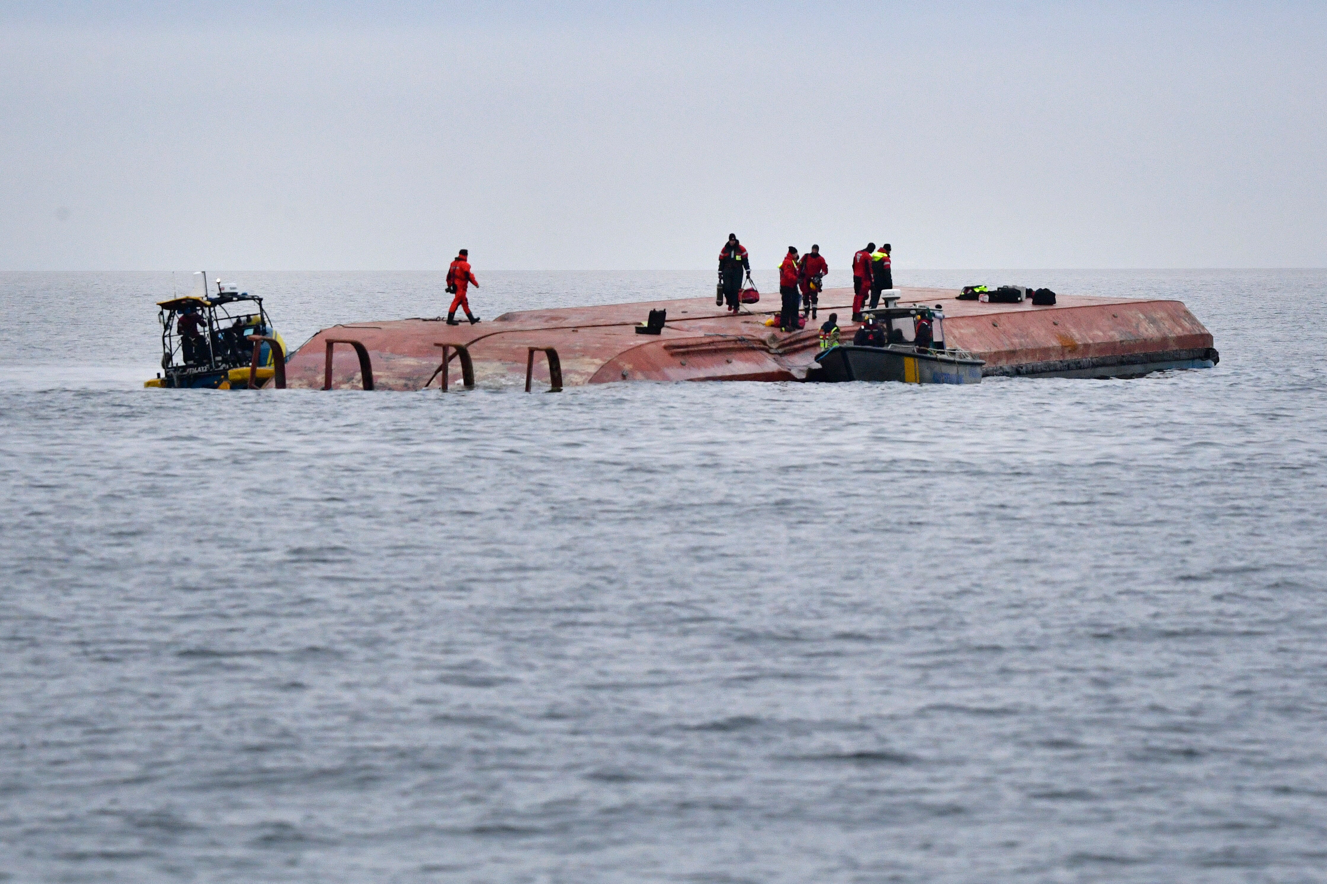 Divers work on the capsized Danish cargo ship Karin Hoej (Johan Nilsson/TT via AP)