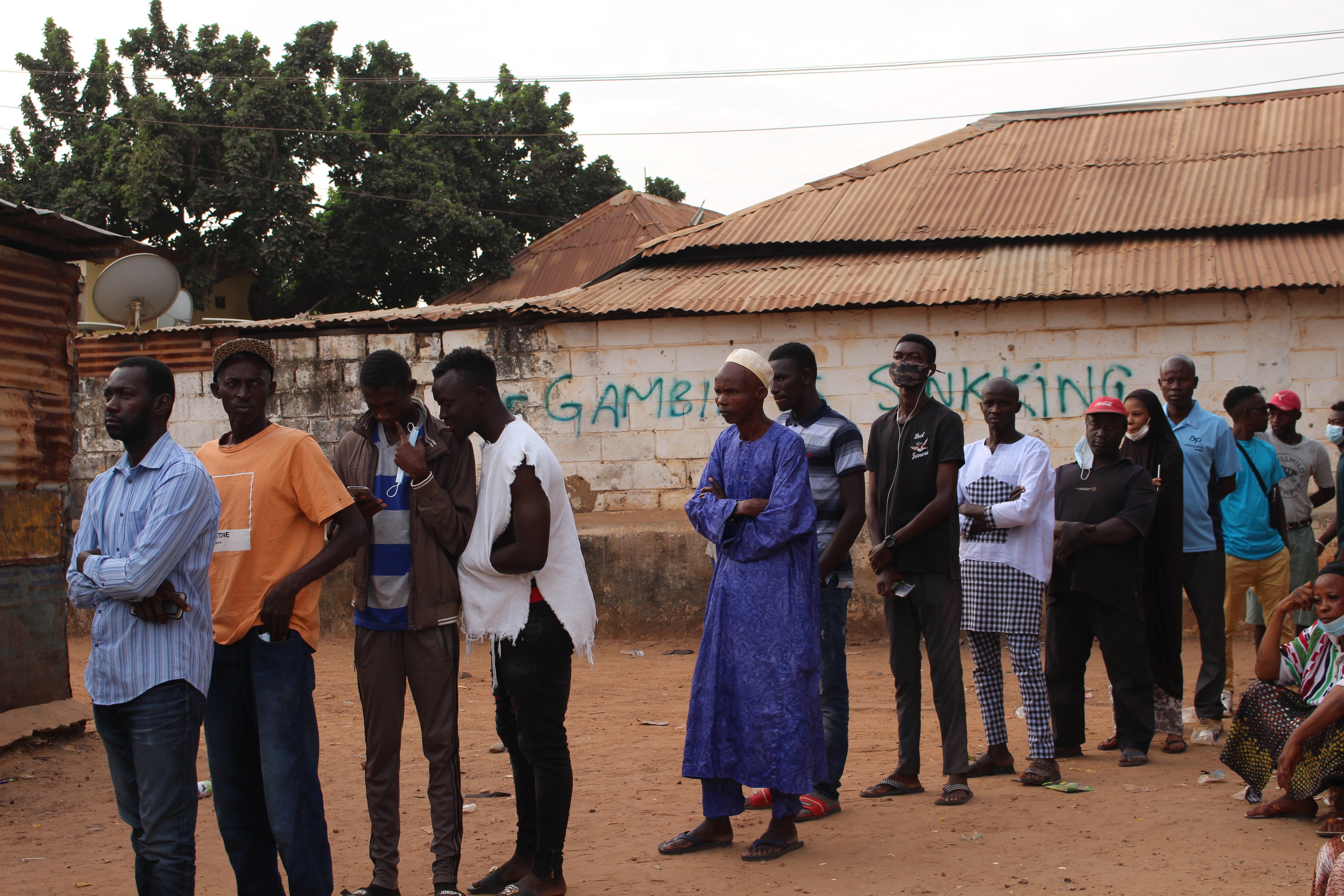 Gambians queue at a polling station in the town of Bakau just after polls opened on 4 December