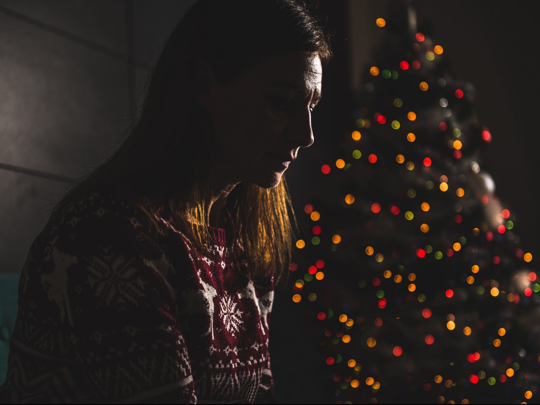 <p>A woman sits alone on Christmas Day</p>