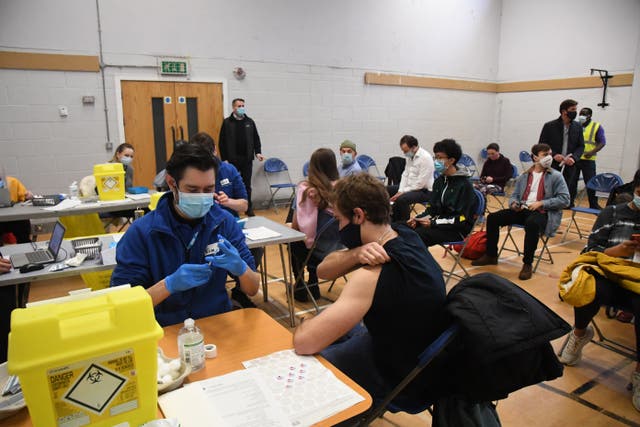 <p>People receiving their Covid booster jabs at the Stow Health Vaccination centre in Westminster </p>