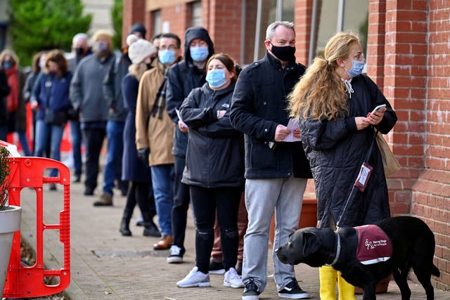 <p>People queue for a Covid vaccine booster</p>